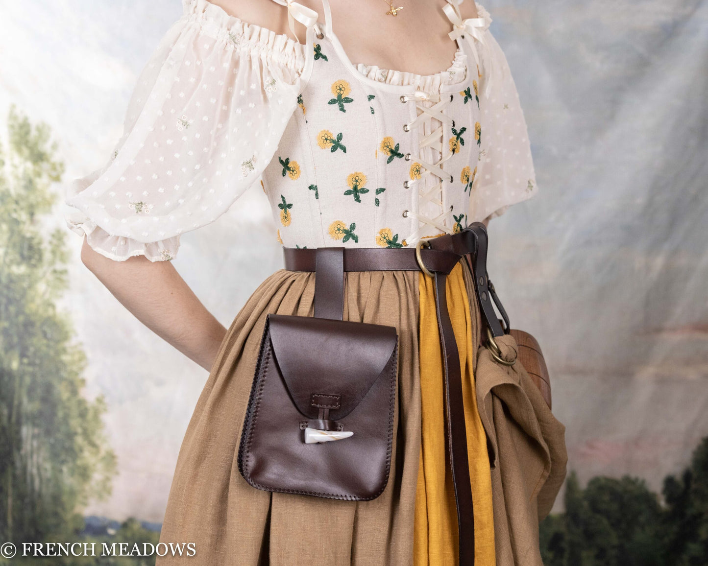 Handcrafted leather belt pouch shown on period costume with floral blouse and gathered skirt in medieval renaissance style