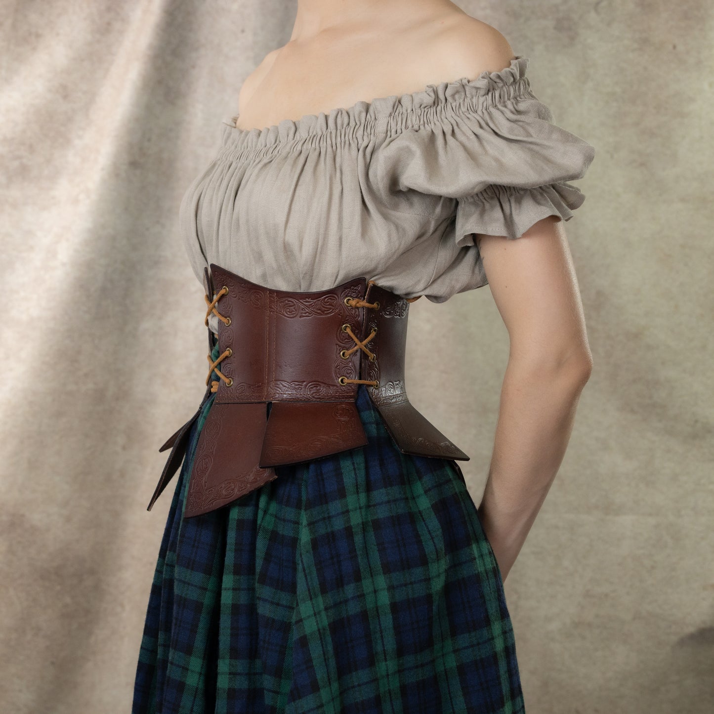 Debossed Leather Underbust Corset worn with peasant blouse and plaid skirt, showing medieval stamped pattern and side lacing