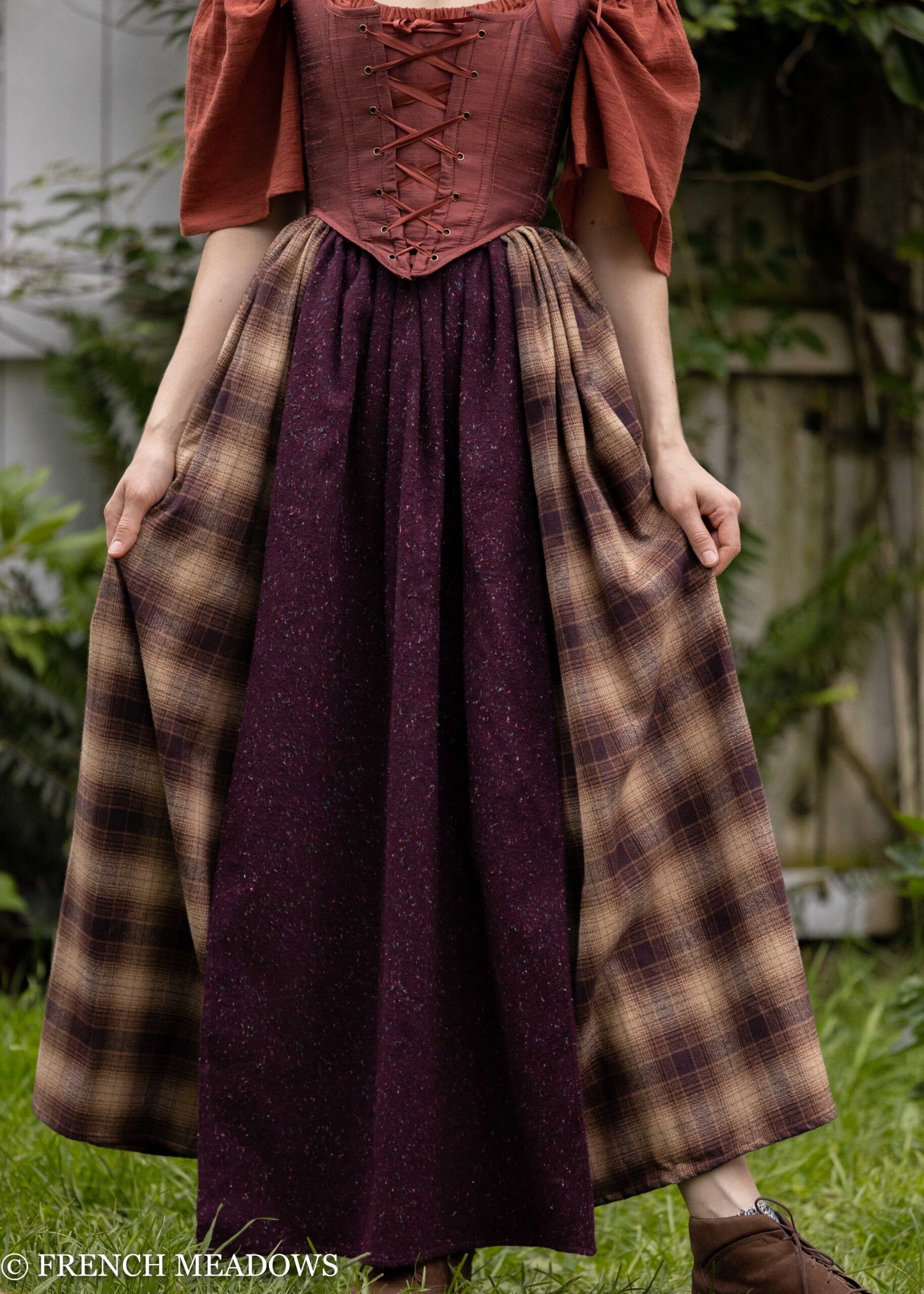 Mary Sanderson Skirt in Brown Plaid with purple apron overlay, inspired by Hocus Pocus, shown outdoors against garden background