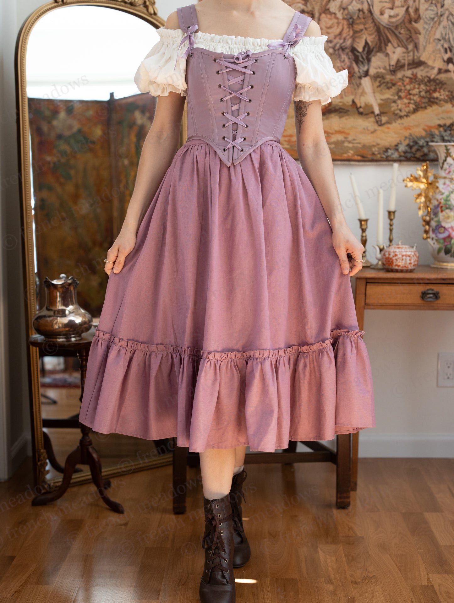 Purple Dusk Satin Corset Top with lace-up bodice and ruffle hem, styled with white puffy sleeves and adjustable straps