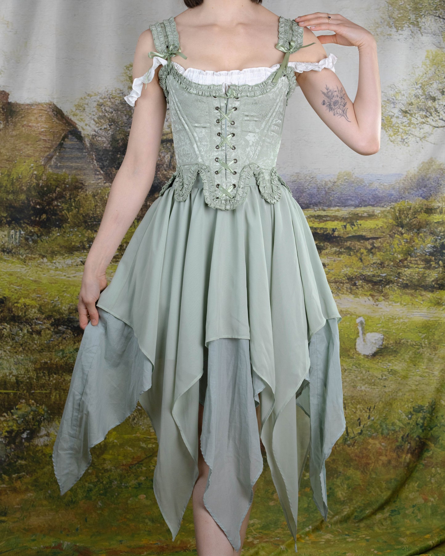Mint Green Floral 18th Century Stays featuring ruffled neckline, waistline details, and front-back lacing in satin floral fabric.