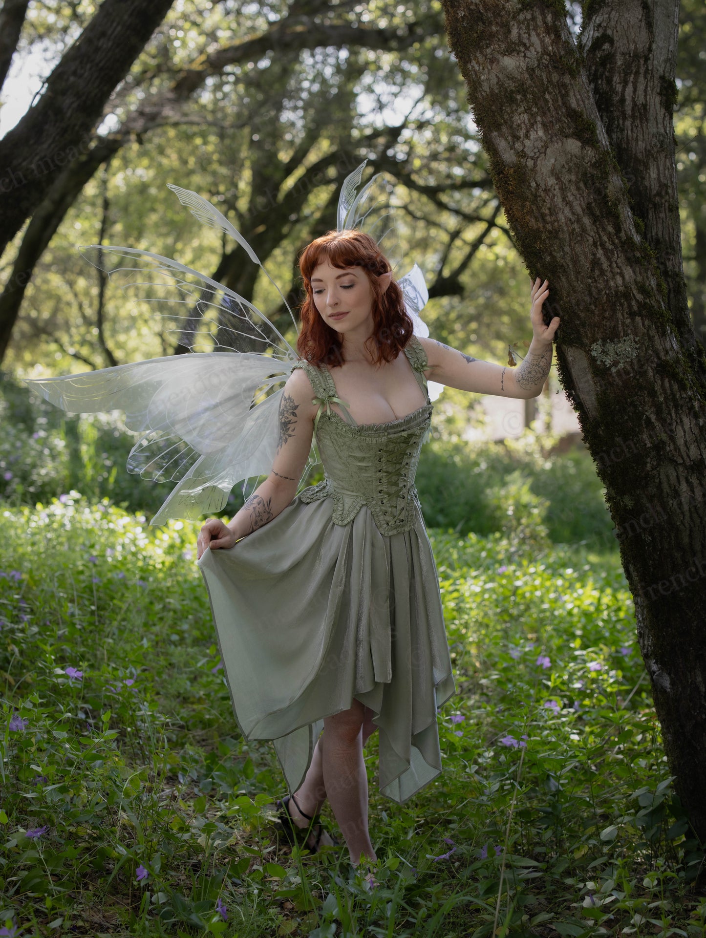 Mint Green Floral 18th Century Stays worn by a woman with fairy wings in a sunlit forest setting.