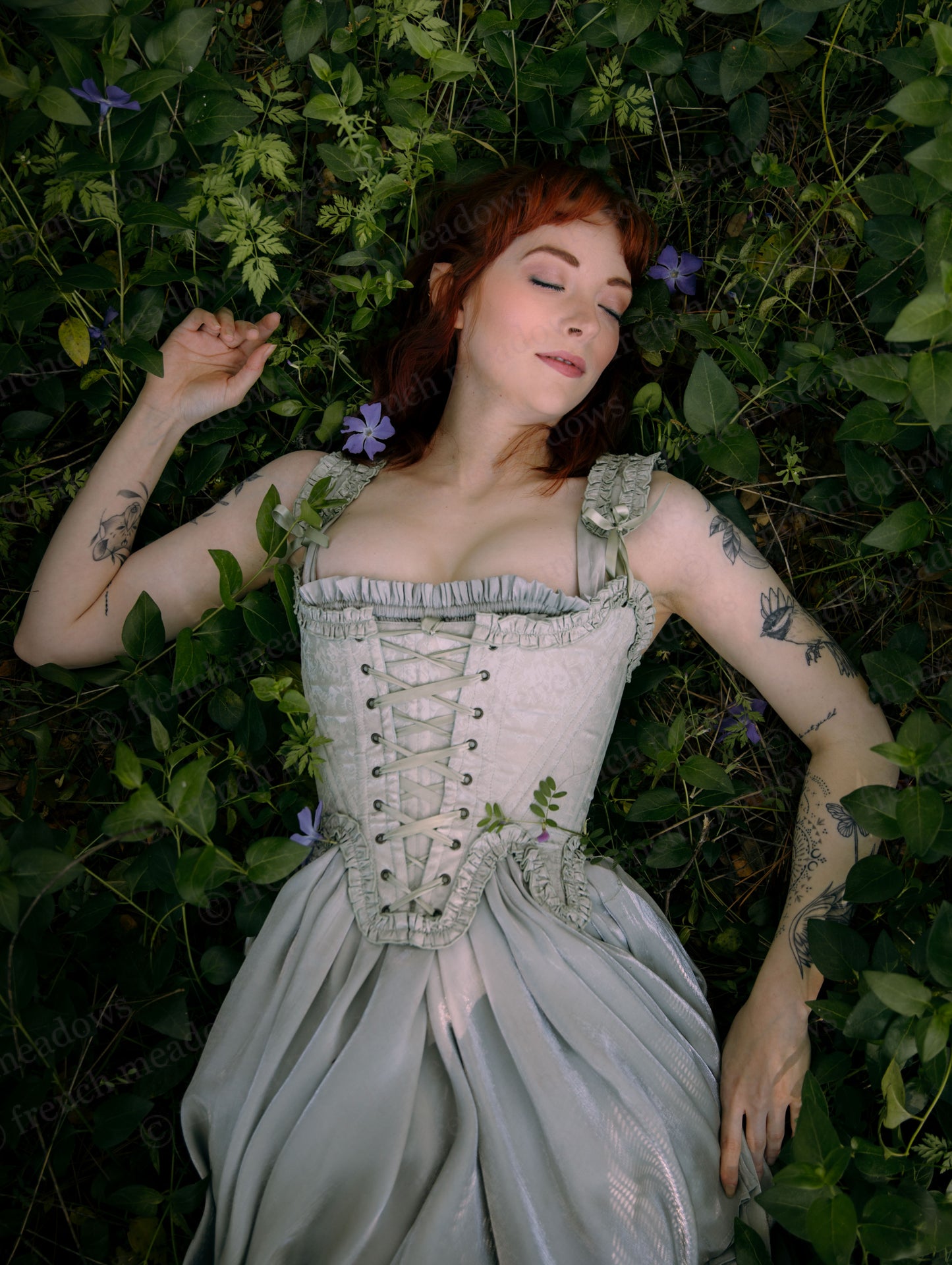 Mint Green Floral 18th Century Stays with ruffle neckline, waist tabs, and front-back lacing in light green satin floral fabric.