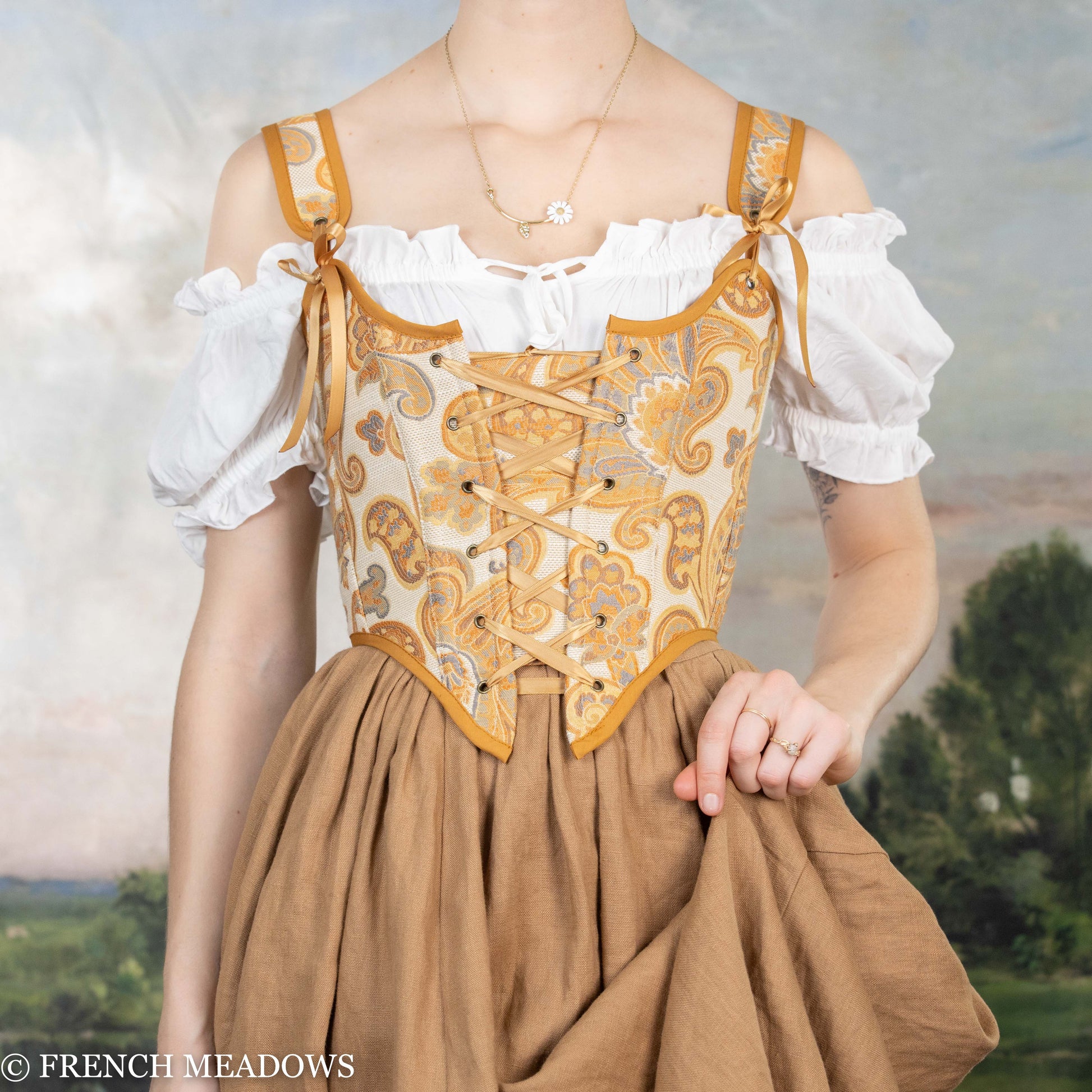 Orange and Yellow Paisley Renaissance Bodice with lace-up front and off-shoulder white blouse, featuring golden trim and baroque pattern