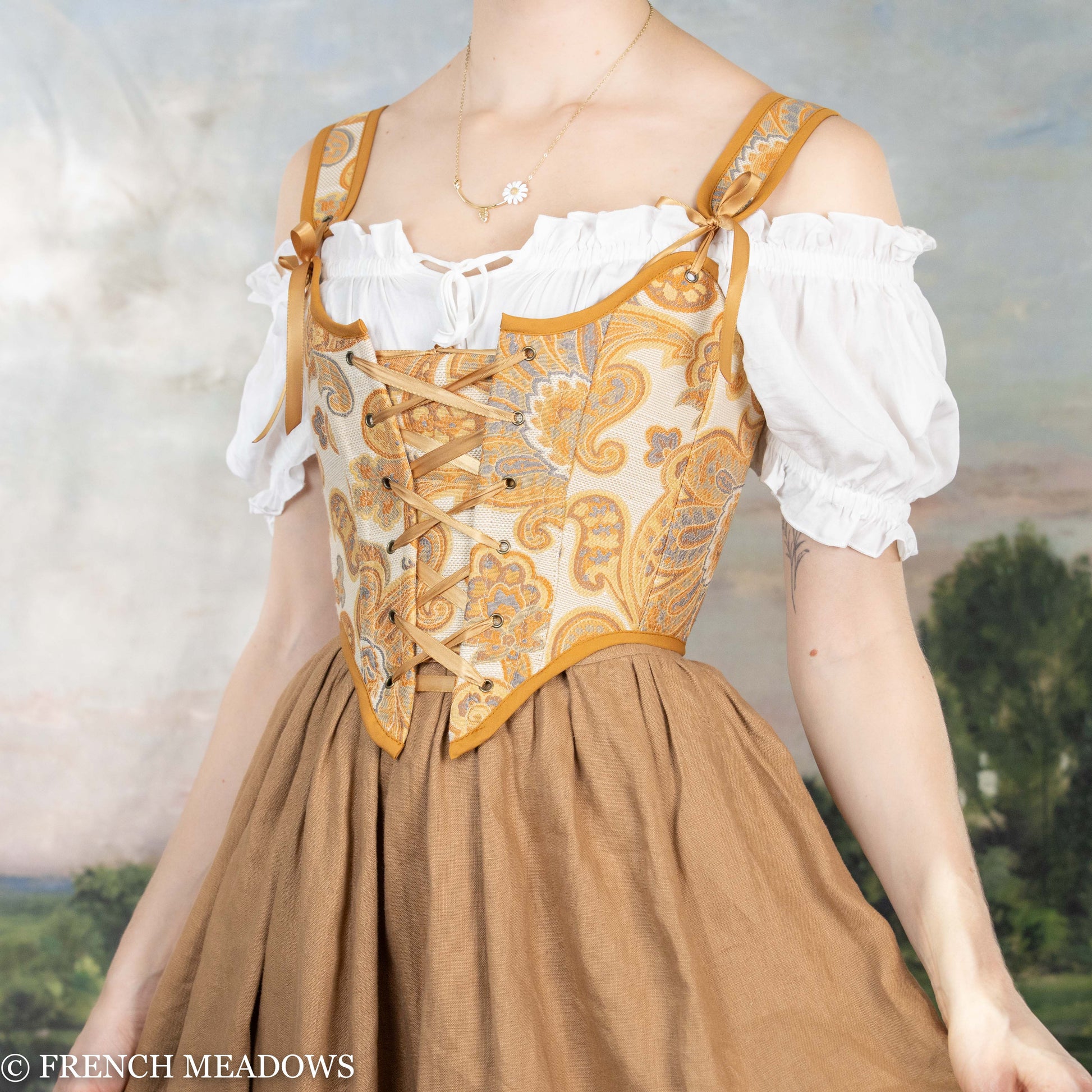 Handmade Renaissance bodice featuring orange and yellow paisley pattern with white peasant blouse and brown gathered skirt