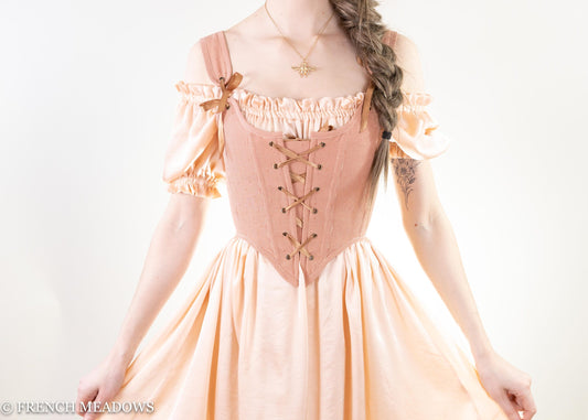 Rose gold Renaissance bodice with Swiss dots and pinstripes, featuring lace-up front and off-shoulder ruffled sleeves