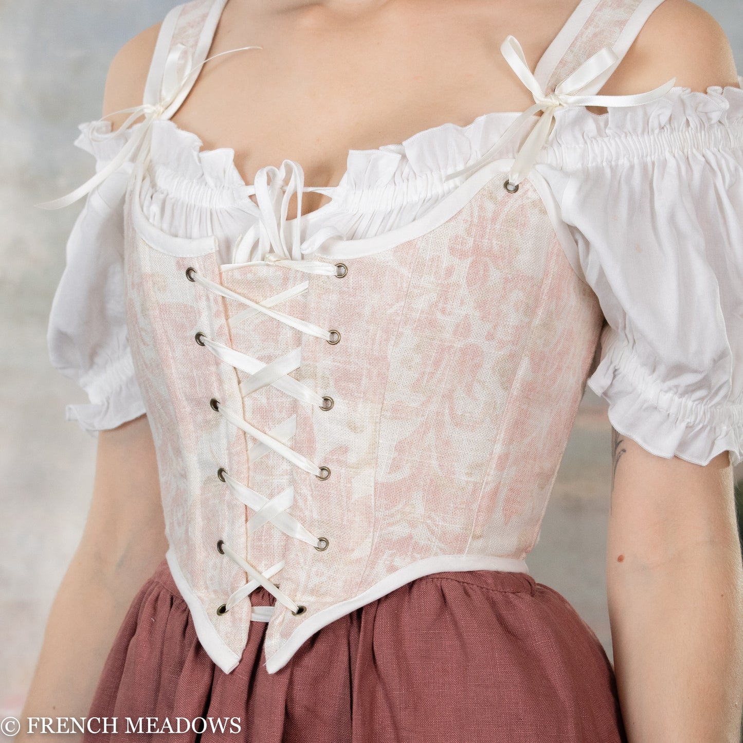 close up view of the pink toile design on the renaissance corset