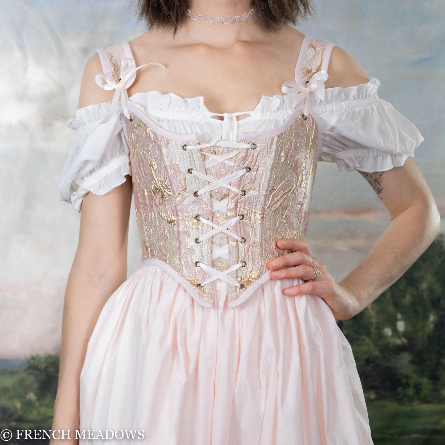 Pink and metallic gold floral Renaissance bodice with lace-up front and off-shoulder white sleeves, featuring delicate floral embroidery