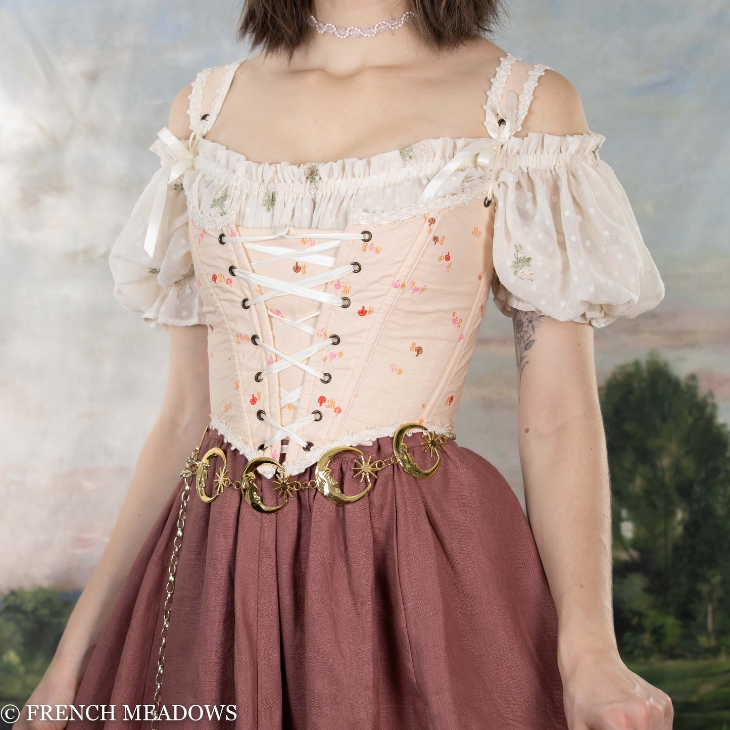 Handmade Ditsy Mushroom Renaissance Bodice with pink floral print, white lace trim, corset lacing, and decorative gold belt rings