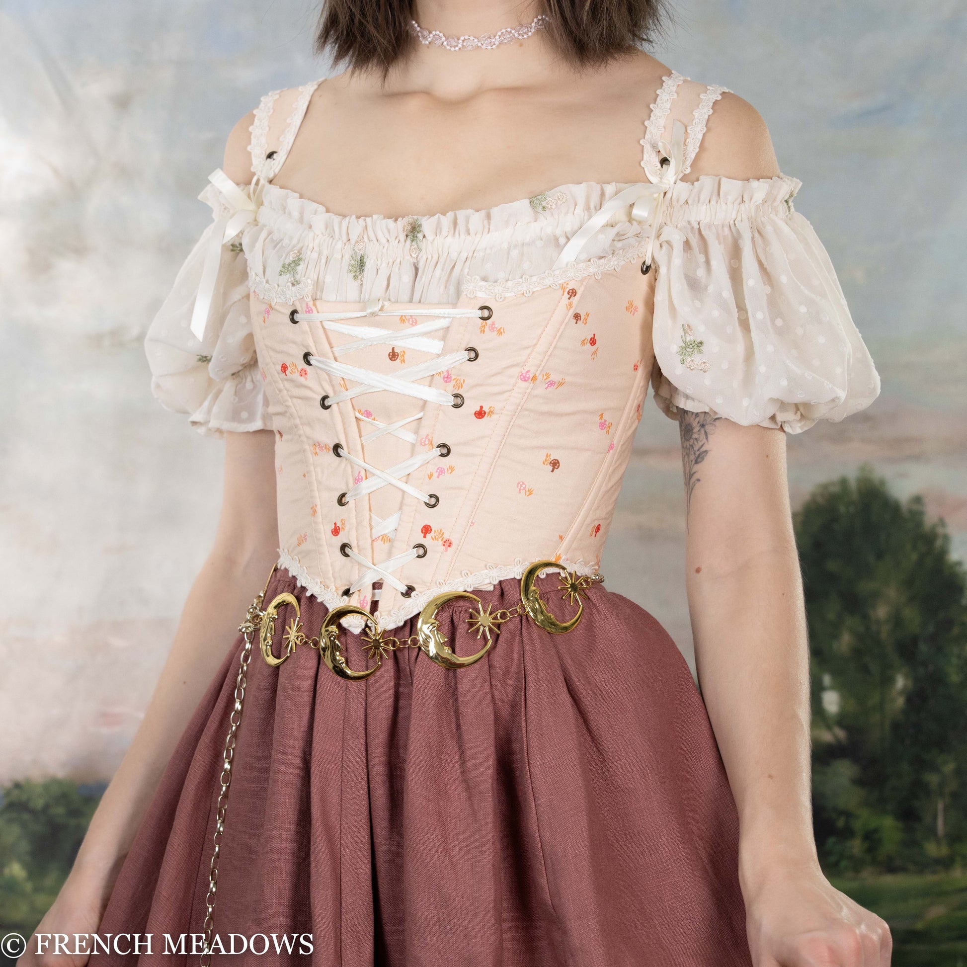 Handmade Ditsy Mushroom Renaissance Bodice with pink floral print, white lace trim, corset lacing, and decorative gold belt rings