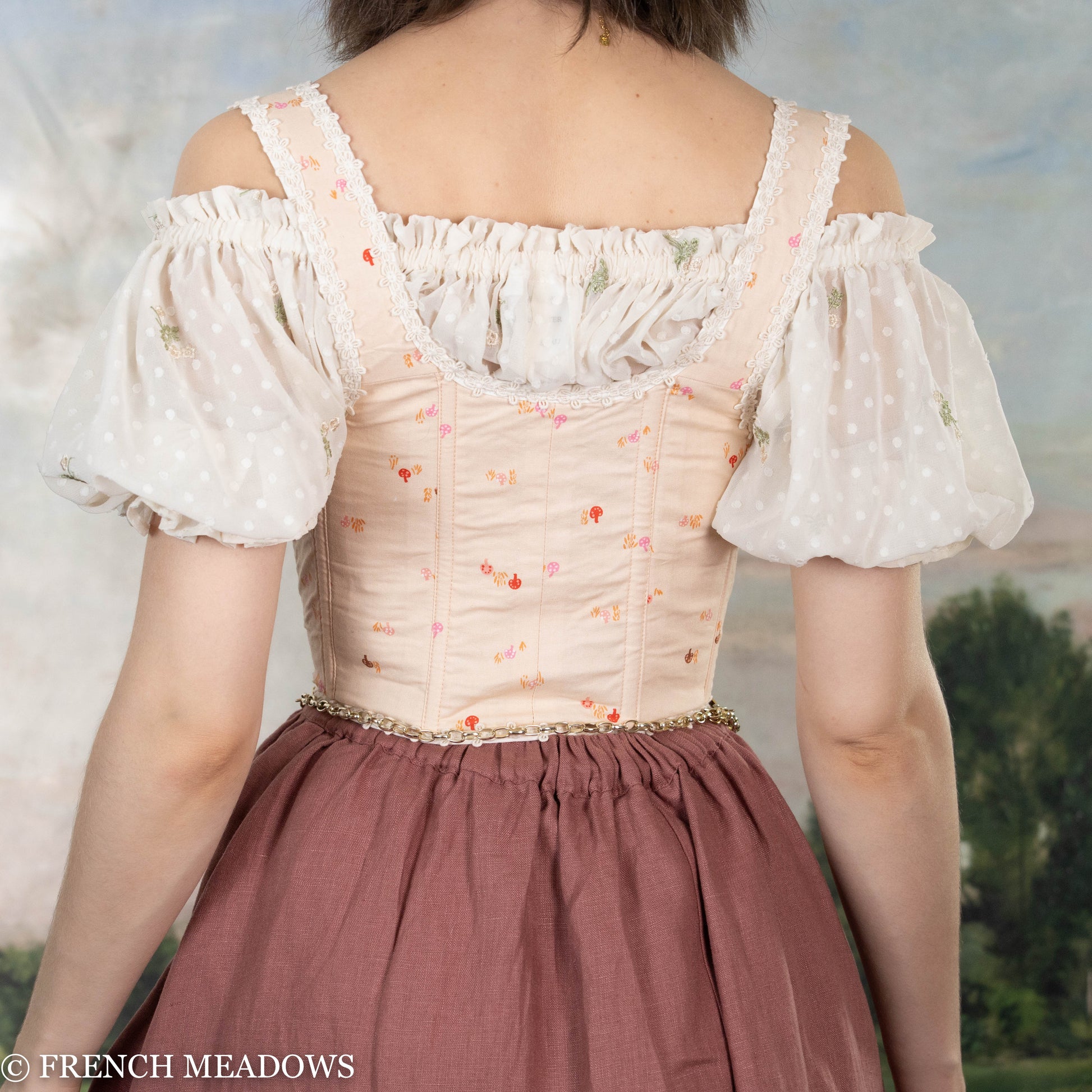 Handmade Ditsy Mushroom Renaissance Bodice with white puff sleeves, pink floral print, and lace trim shown from back view