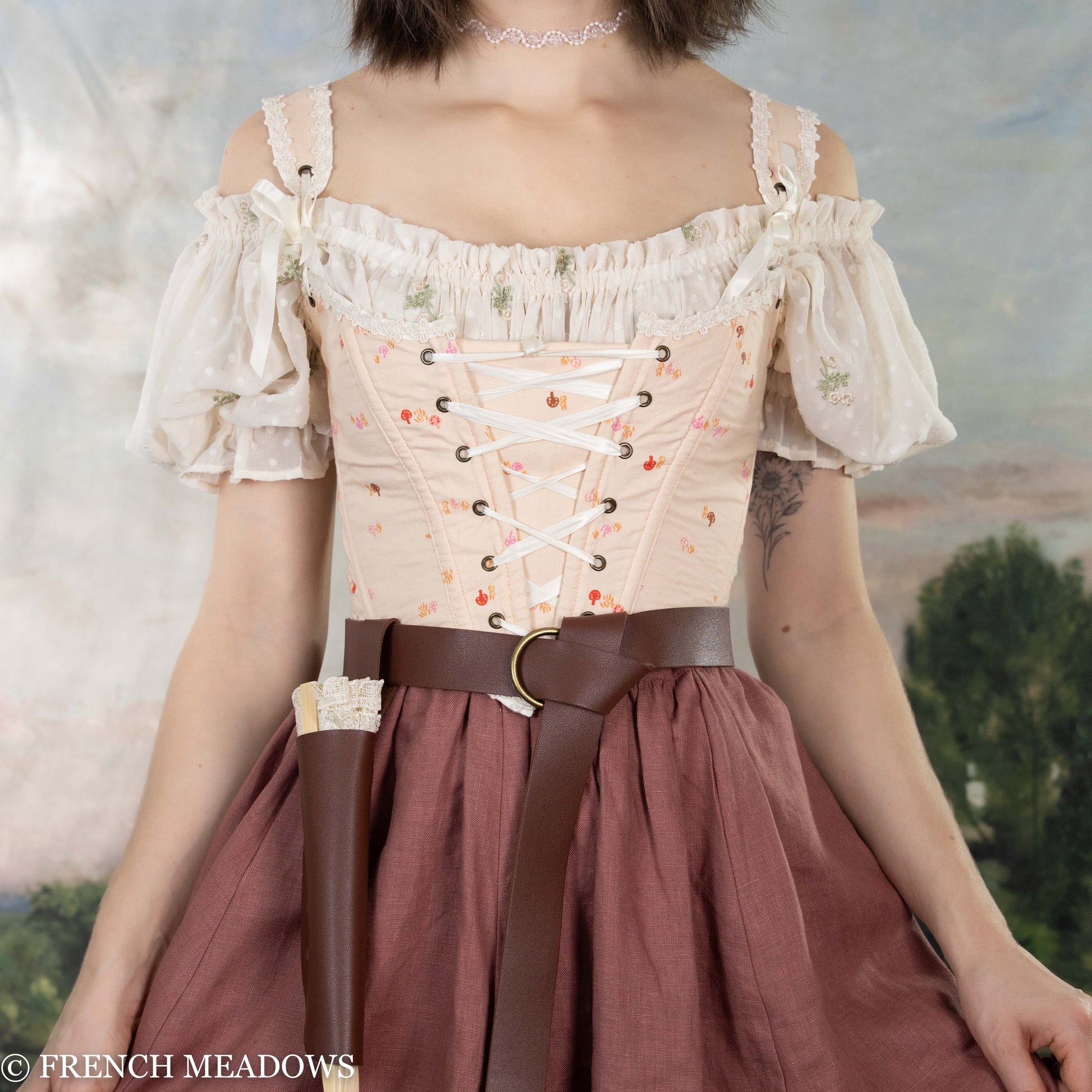 Handmade Ditsy Mushroom Renaissance Bodice featuring pink fabric with mushroom print, lace-up front, daisy crochet trim and puffy sleeves