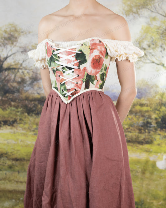 Pink Peony Floral Corset Top with watercolor floral print, lace-up design, and off-shoulder ruffle sleeves against mauve skirt