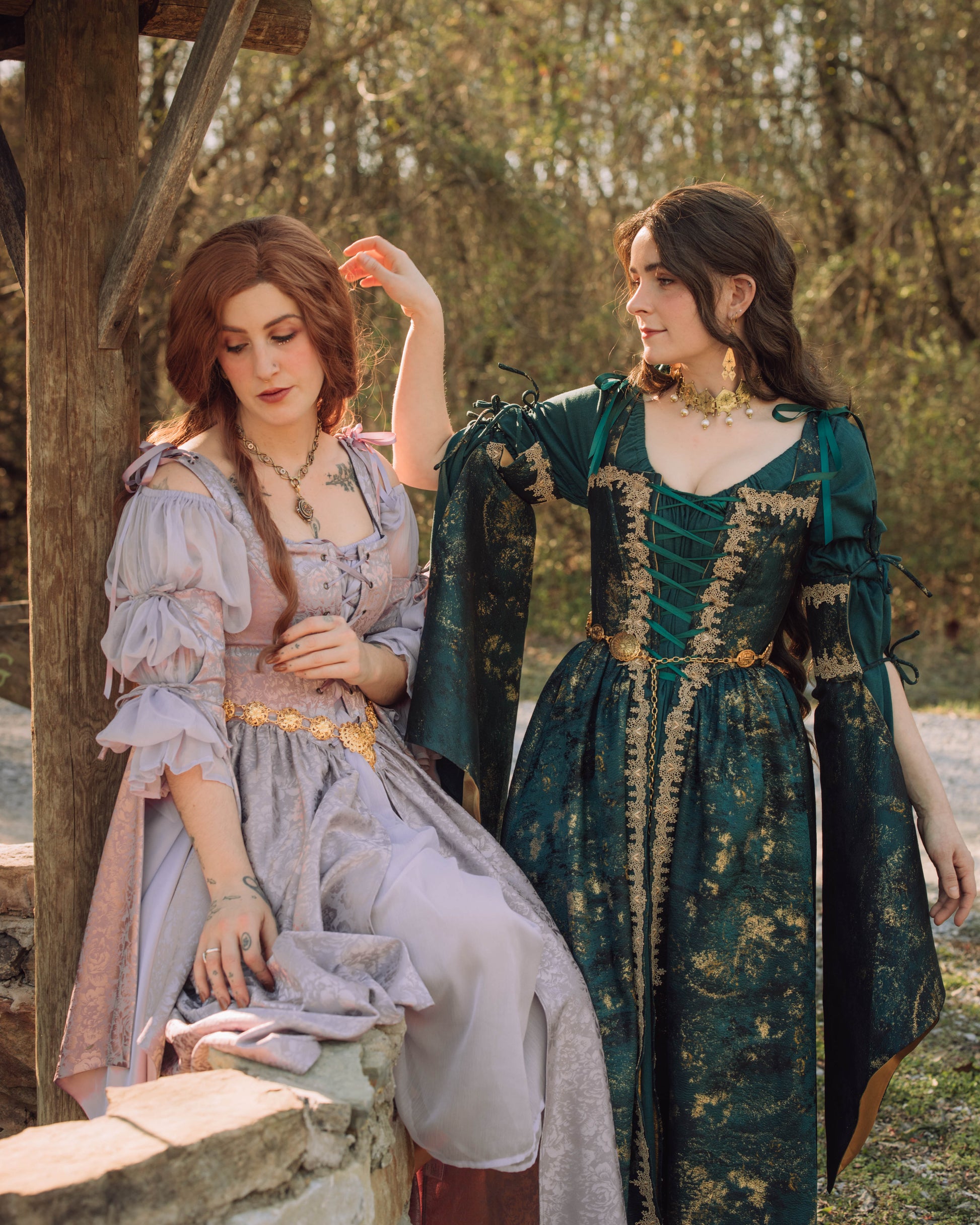 Lavender floral satin corset dress shown against rustic woodland setting with medieval fantasy styling