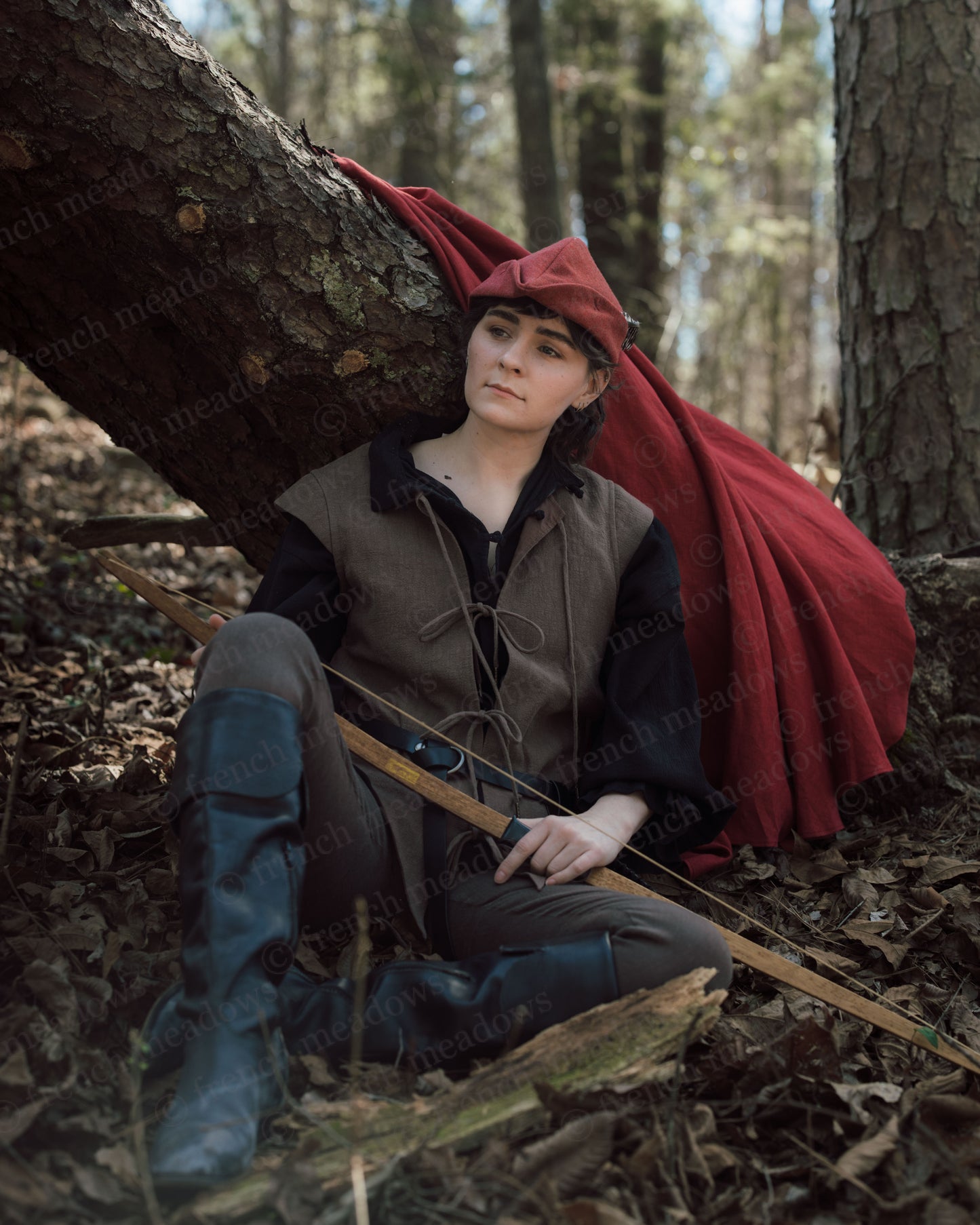 Brown Bard Vest shown in forest setting with red cloak, boots and bow, capturing medieval adventurer aesthetic