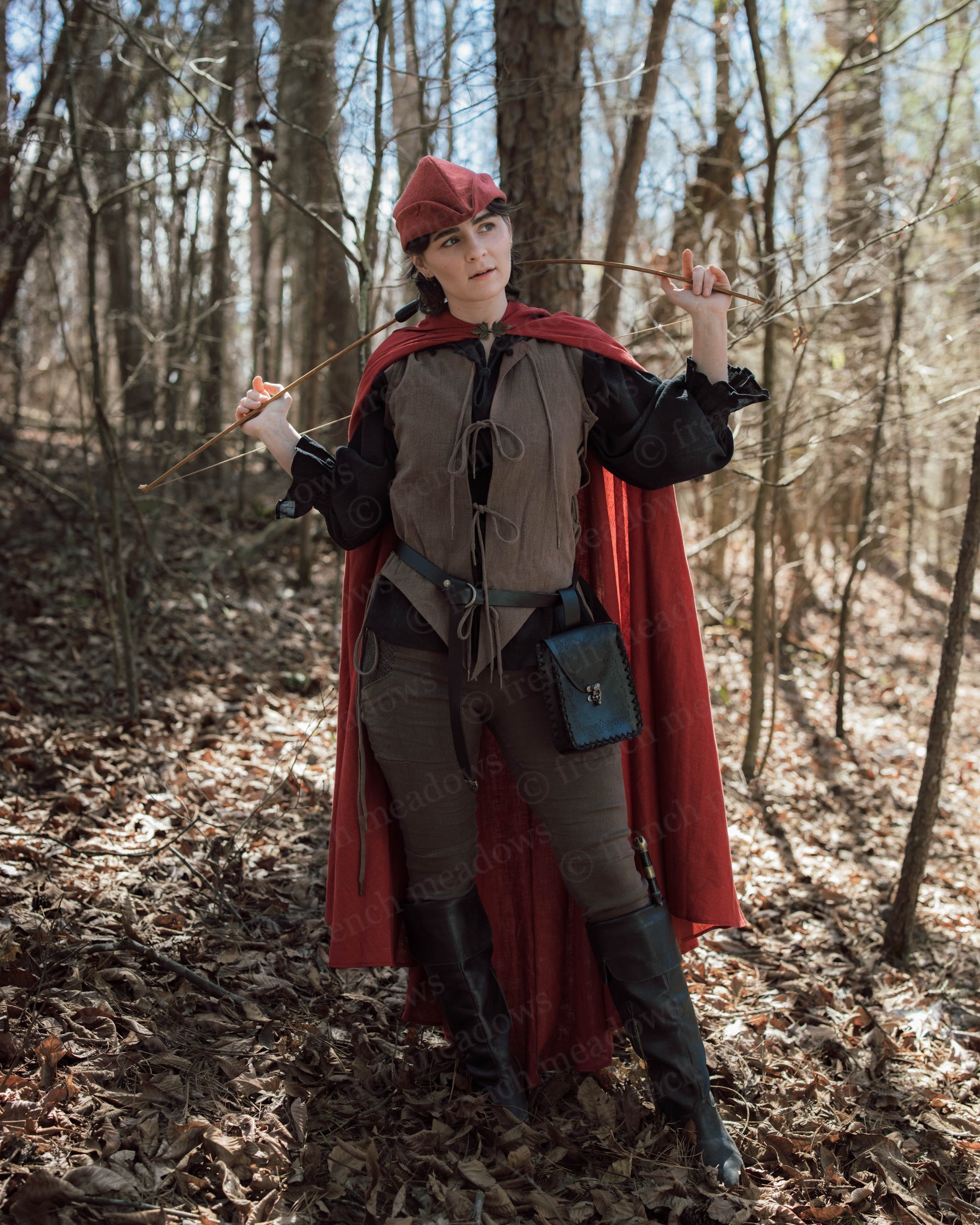 Brown Bard Vest shown with red cape and matching cap in forest setting, styled for renaissance faire costumes