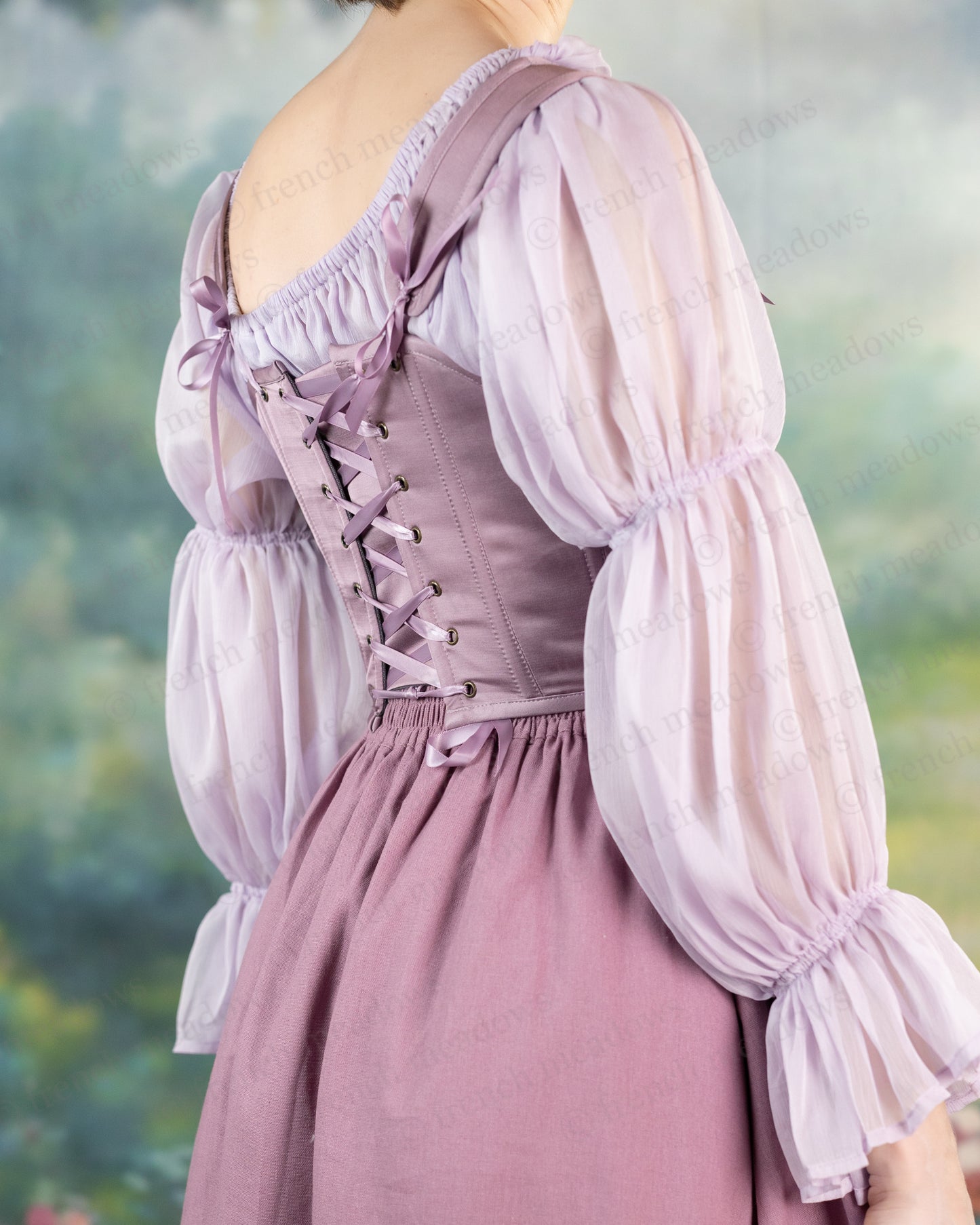 Purple Dusk Satin Corset Top featuring lace-up back detail, puff sleeves, and gathered satin fabric in ethereal dusty purple shade