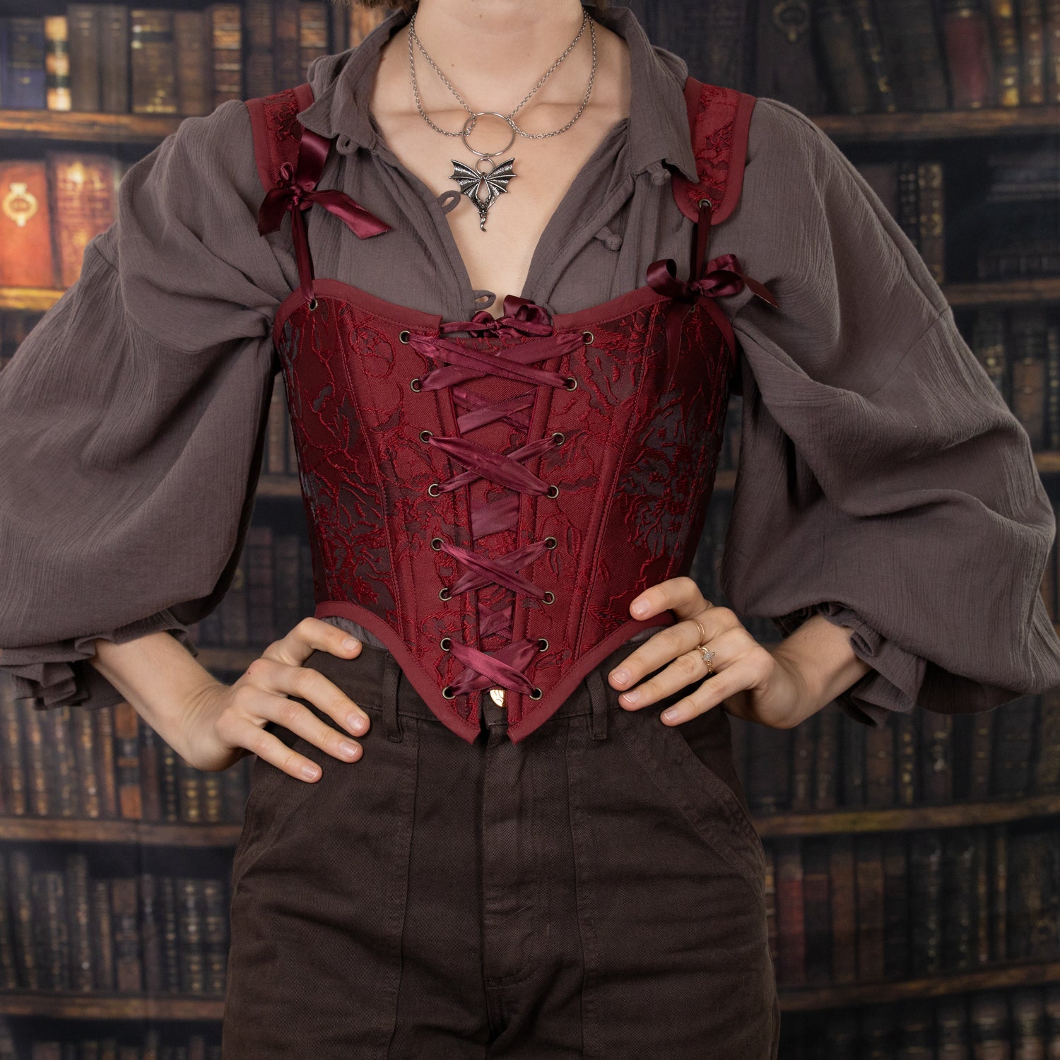 pirate costume with dark brown darcy shirt, brown trousers, and red embroidered brocade corset
