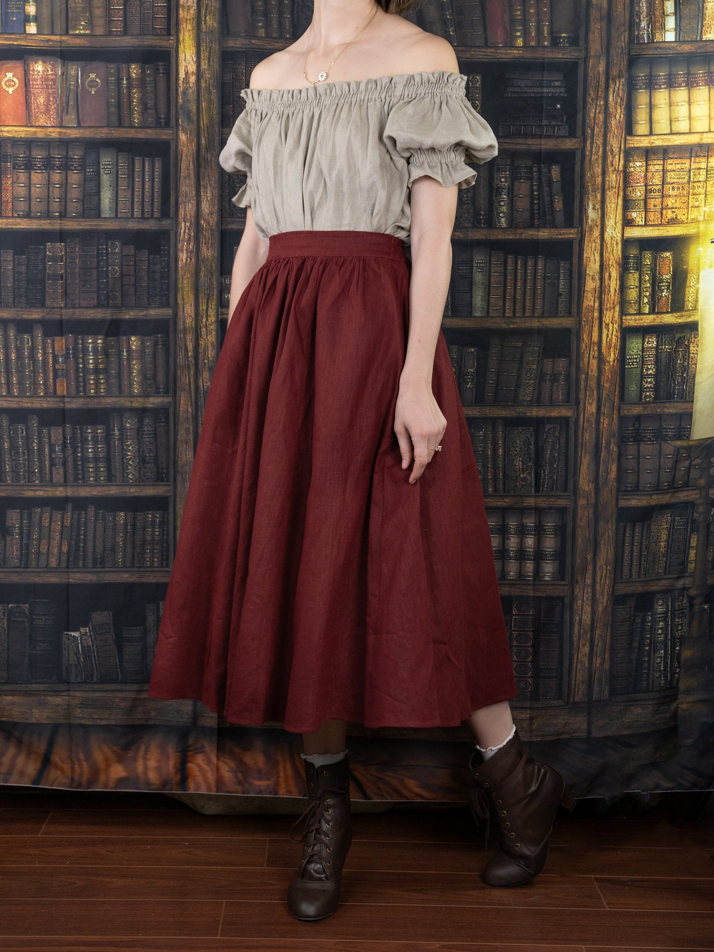 Burgundy Ramie Midi Skirt shown with off-shoulder peasant top in library setting, styled for renaissance and cottagecore fashion