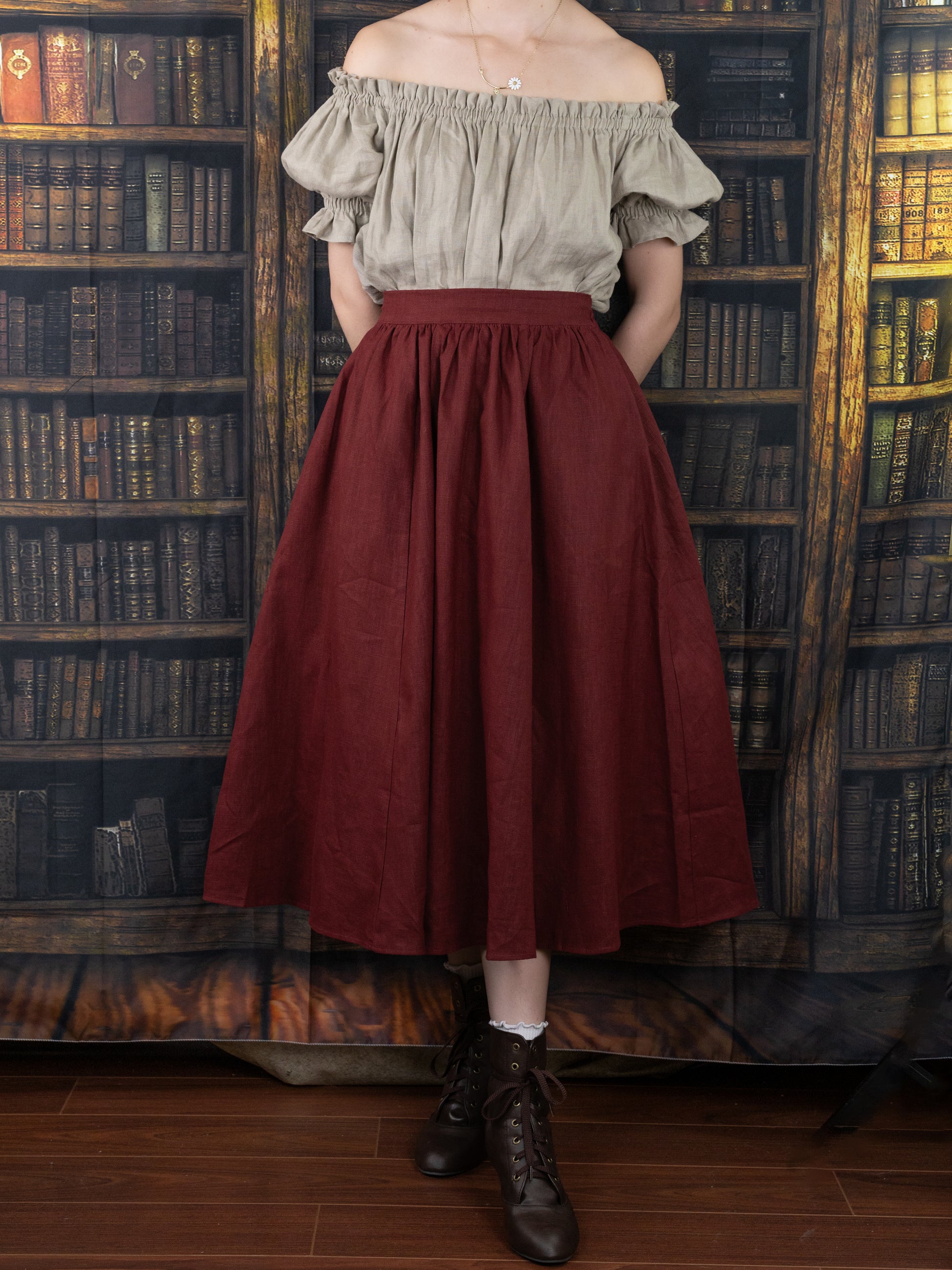 Burgundy Ramie Midi Skirt shown on model with off-shoulder blouse in vintage library setting, featuring full gathered skirt style