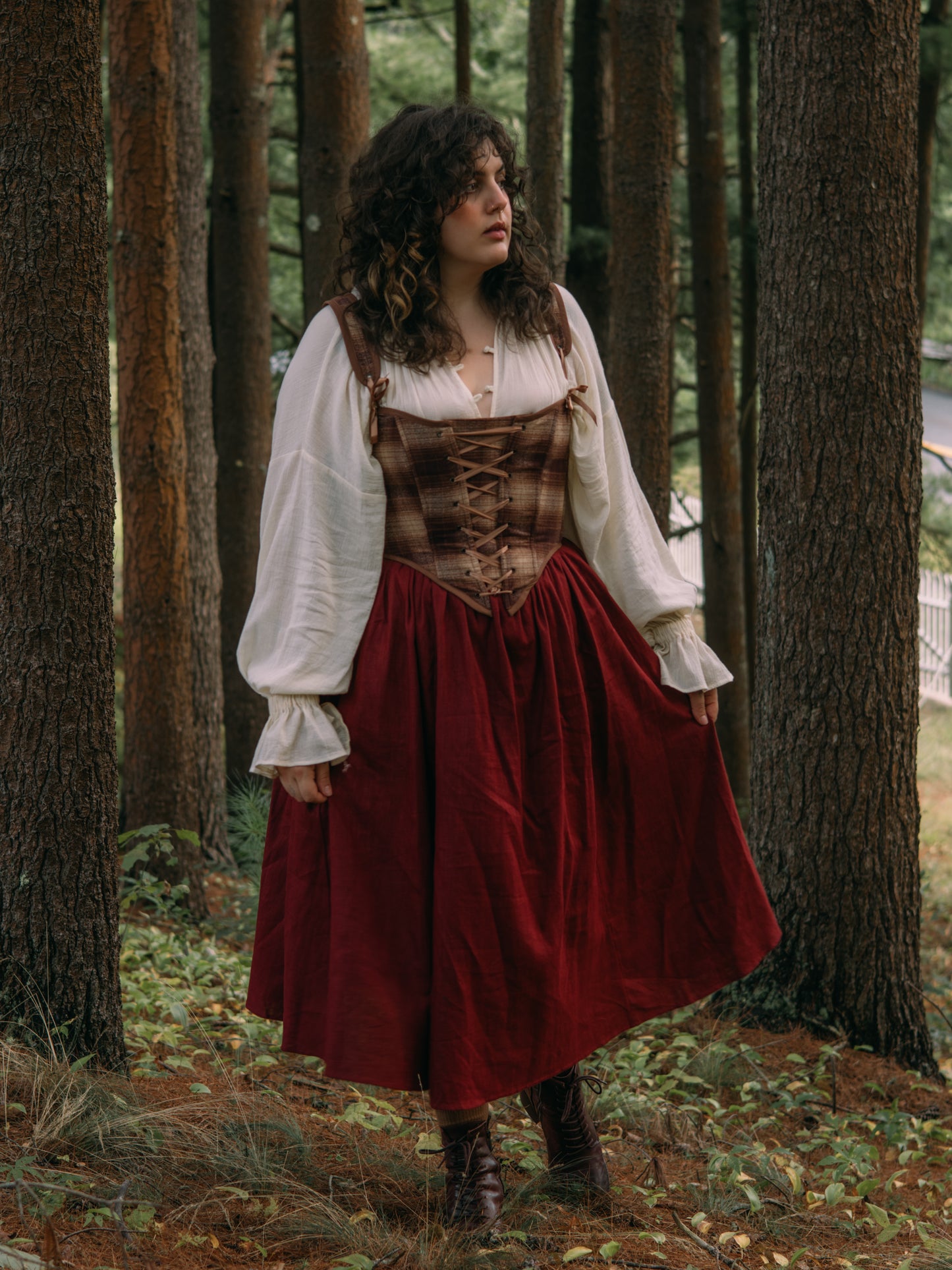 Burgundy Ramie Midi Skirt styled with brown corset and white peasant blouse in forest setting, shown in renaissance faire aesthetic