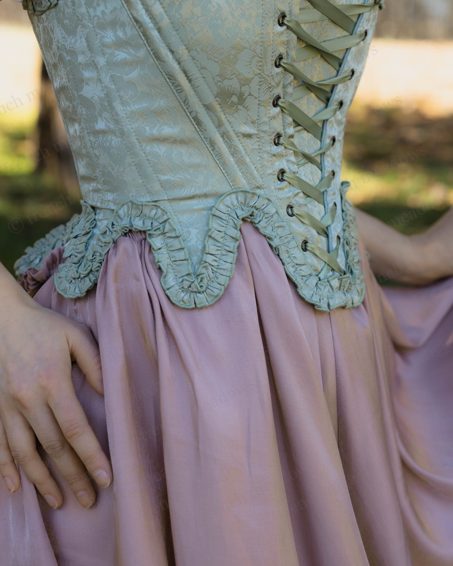 Mint Green Floral 18th Century Stays with ruffled neckline, waistline details, and front-back lacing satin corset.