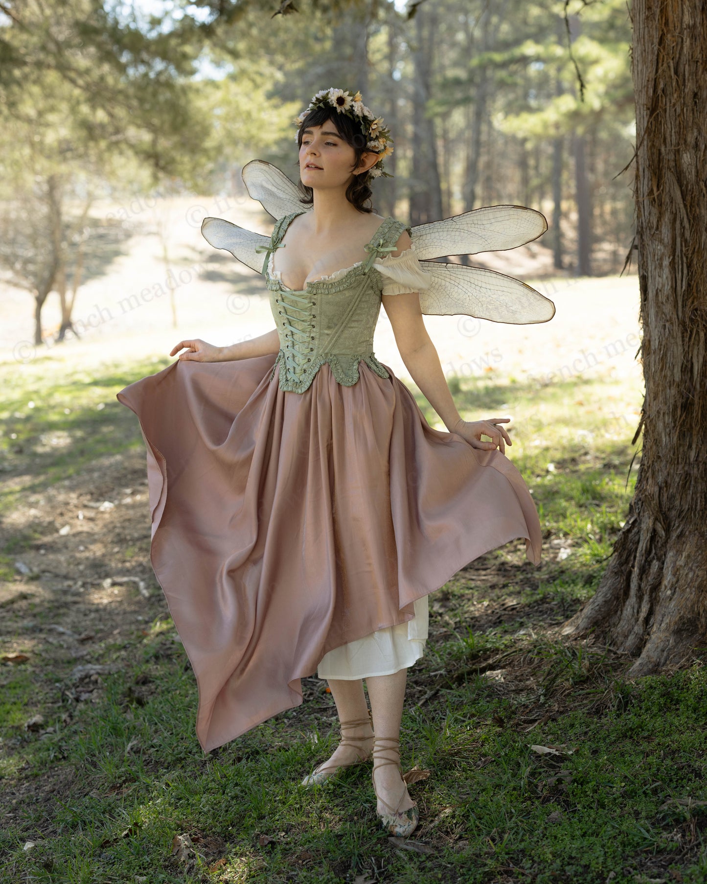 Woman wearing Mint Green Floral 18th Century Stays with ruffled neckline and waistline in an outdoor forest setting.