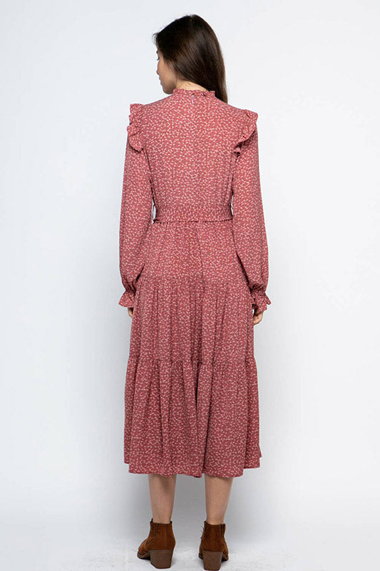Ruffled Prairie Dress in mauve with ditsy floral print, featuring long bishop sleeves and tiered skirt, shown from back view