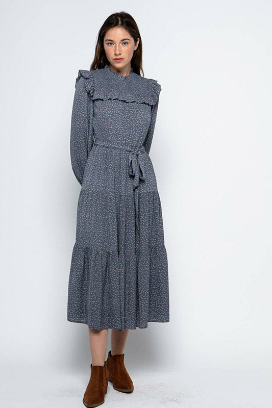 Ruffled Prairie Dress in blue floral pattern with smocked yoke, bishop sleeves and tiered skirt with waist tie