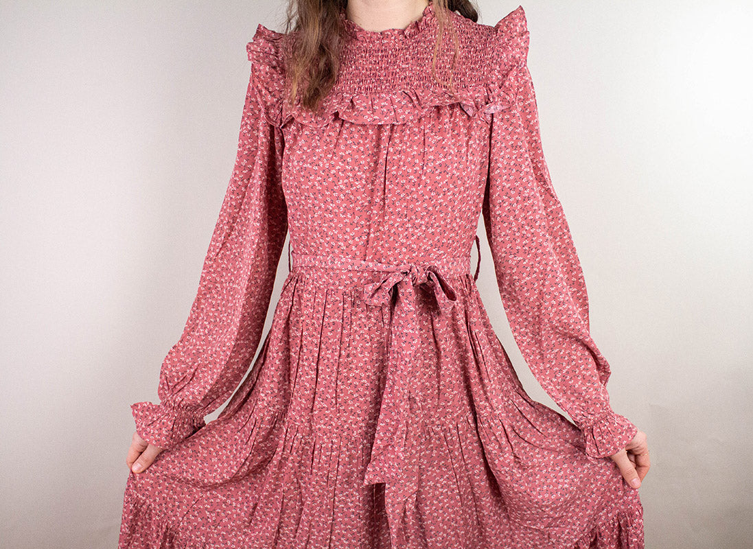 Ruffled Prairie Dress in mauve with smocked yoke, floral print, bishop sleeves and tiered skirt with tie waist