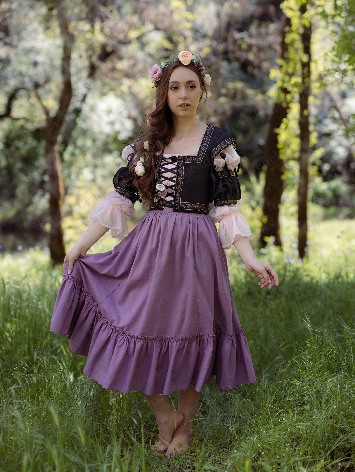 Woman in forest wearing a Mauve Linen Ruffle Skirt with elastic waistband and floral crown styling a renaissance look.