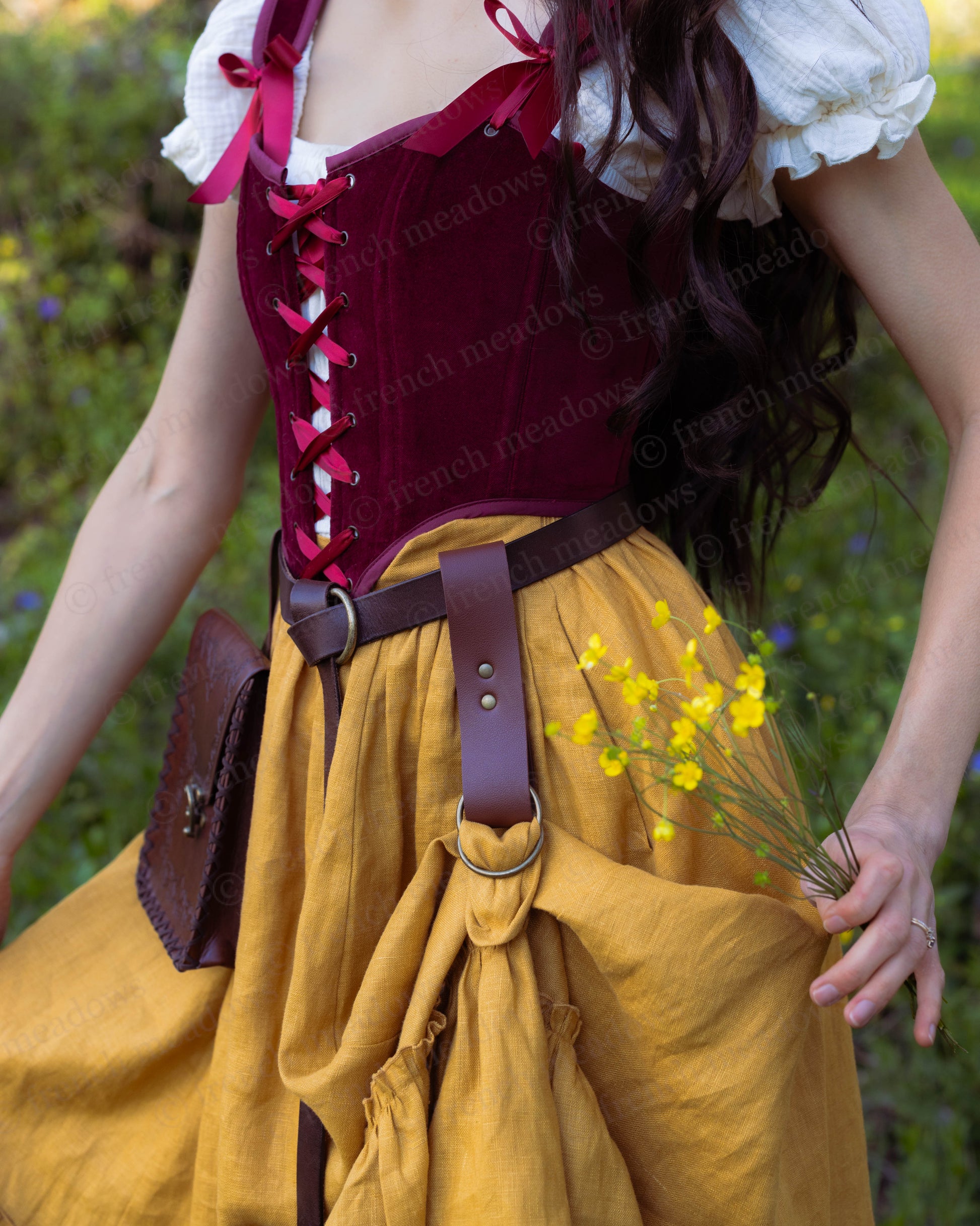 Vegan Leather Skirt Hikes attached to belt lifting mustard renaissance skirt, showing fullness and layers.