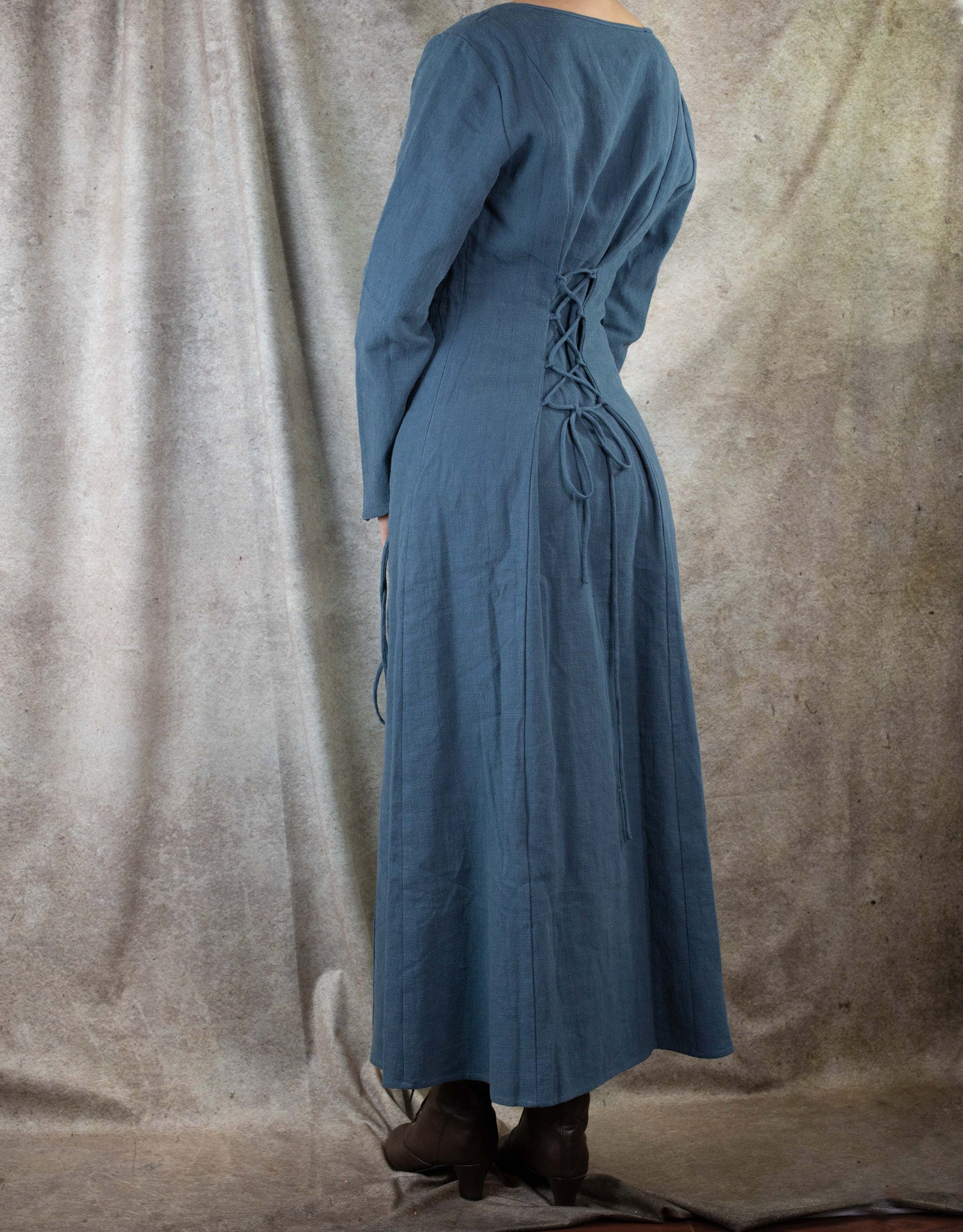 Teal Viking dress shown from back view with laced corset detail and long fitted sleeves in textured cotton-ramie fabric