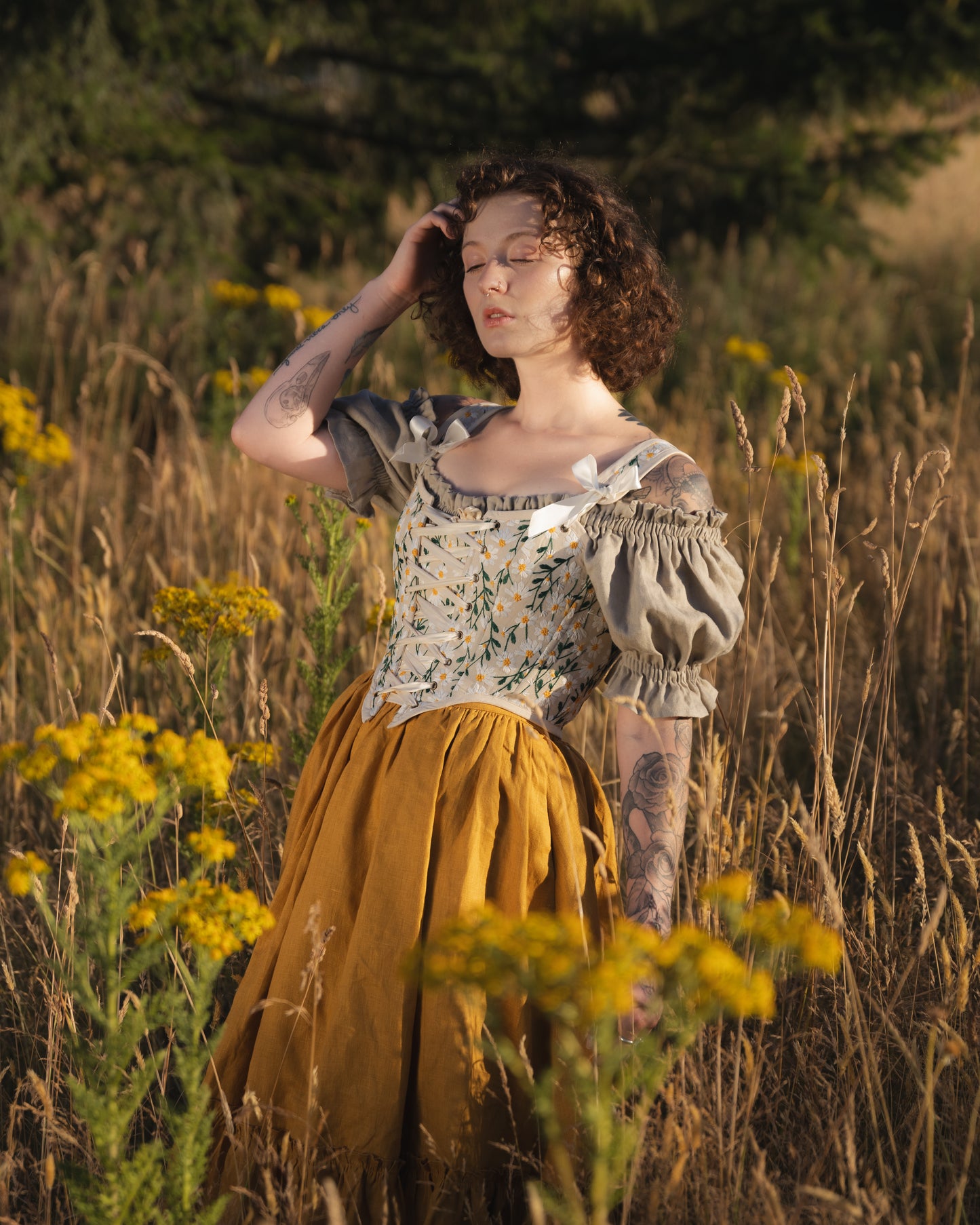 Embroidered Daisies Corset Top with puff sleeves shown in golden meadow setting with floral embroidery and mustard skirt