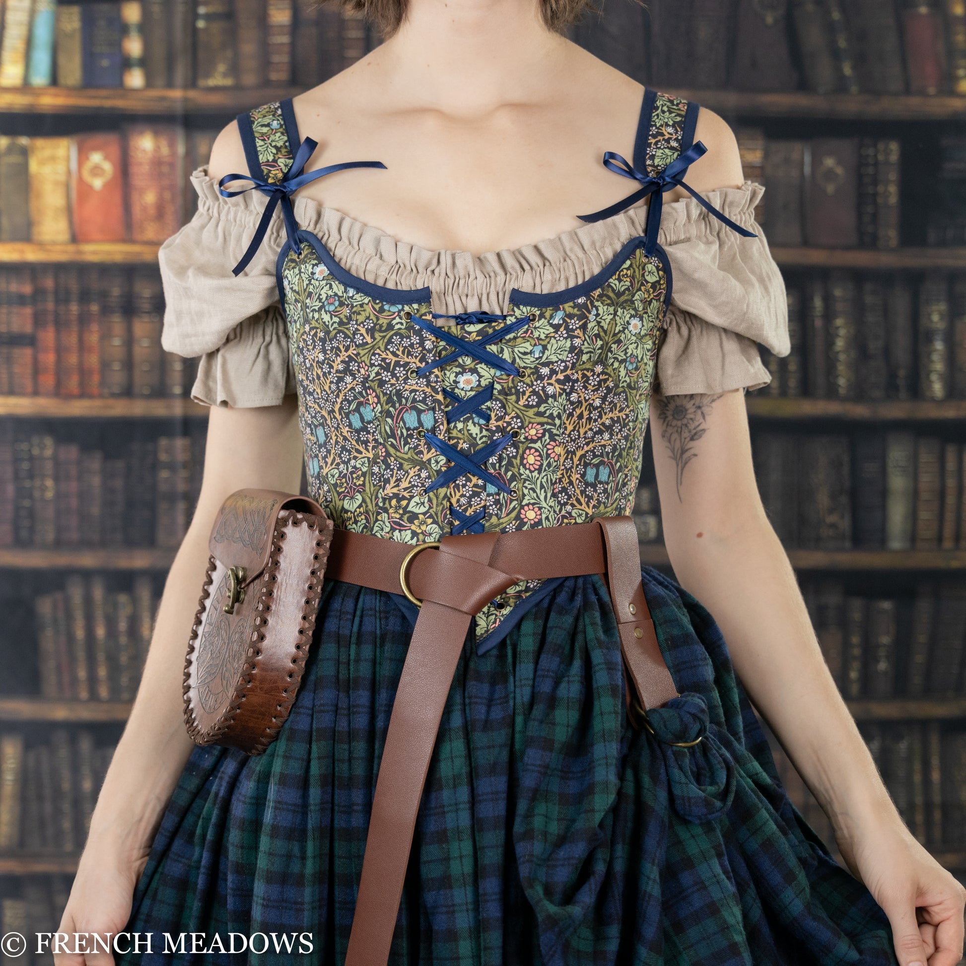 Vegan leather skirt hikes shown with renaissance costume featuring floral bodice, plaid skirt and brown leather belt and pouch