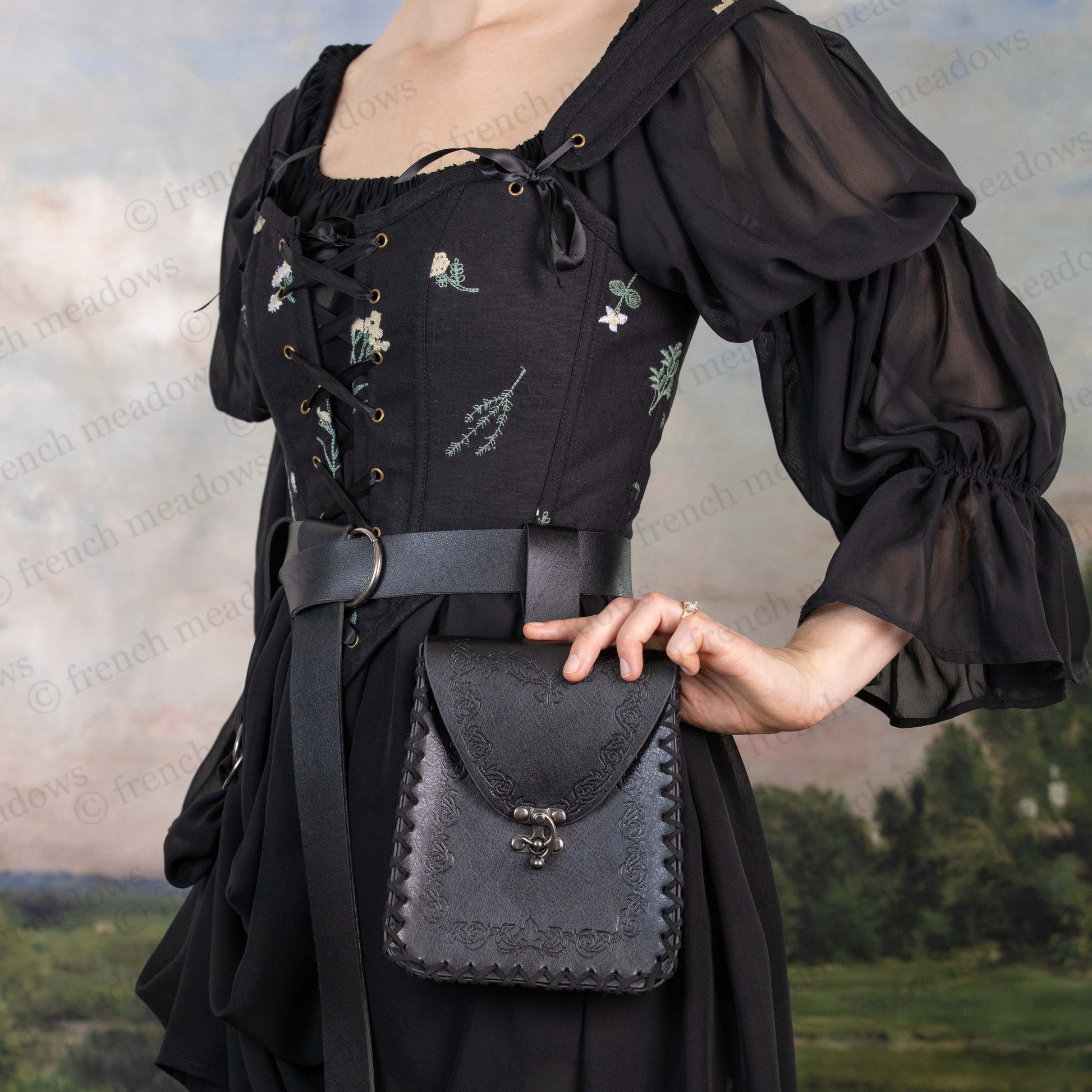 Elven Medieval Belt Pouch in black vegan leather with decorative scroll design shown on medieval dress with belt