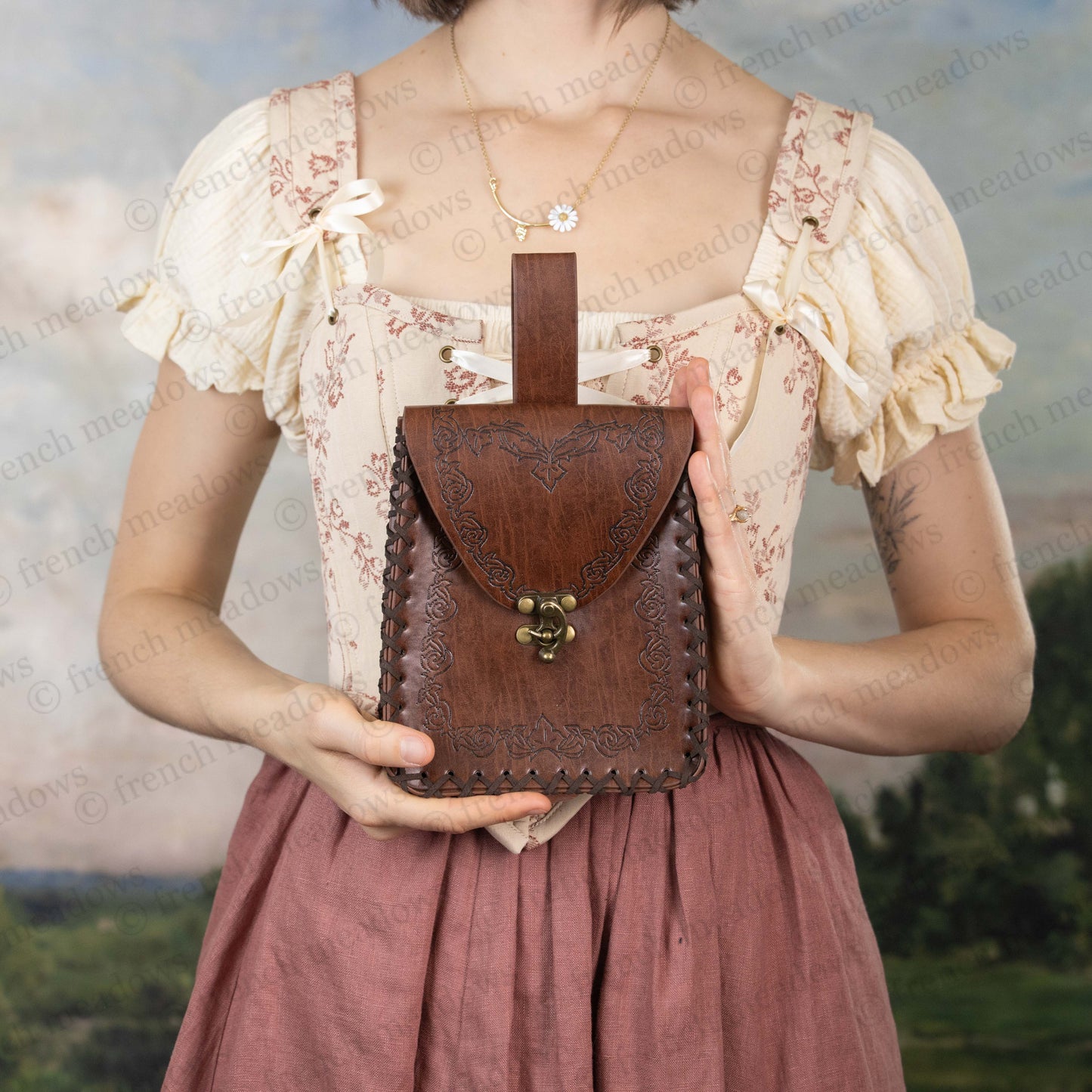 Brown Elven Medieval Belt Pouch with ornate scroll design, metal clasp, and belt loop shown against renaissance dress