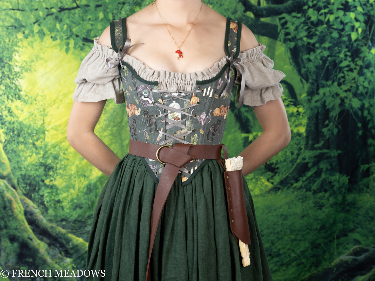 Fan Holster shown on renaissance dress with brown leather belt, floral bodice and ruffled off-shoulder sleeves against forest backdrop
