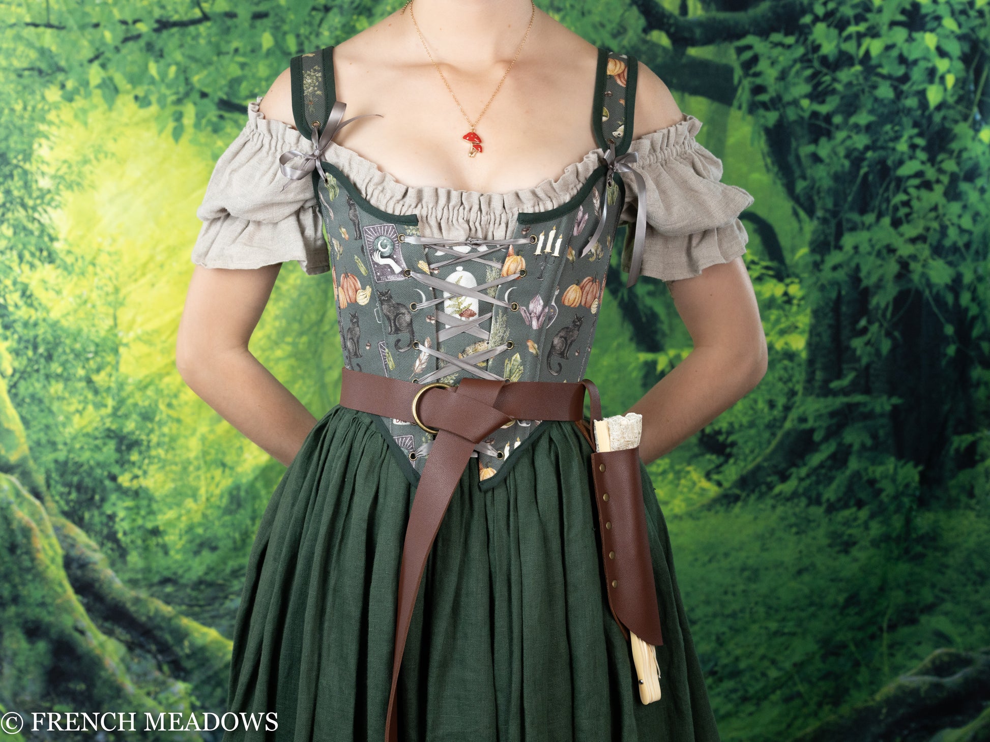 Fan Holster shown on renaissance dress with brown leather belt, floral bodice and ruffled off-shoulder sleeves against forest backdrop