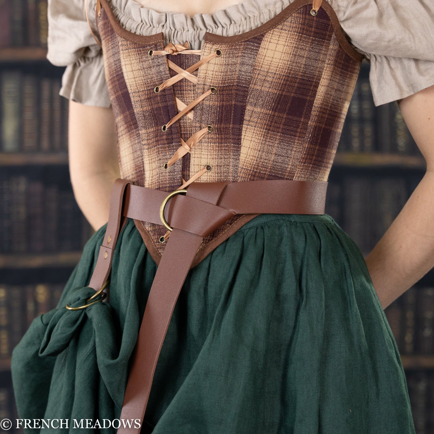 Brown vegan leather renaissance belt worn with plaid corset and green dress, showcasing medieval costume styling