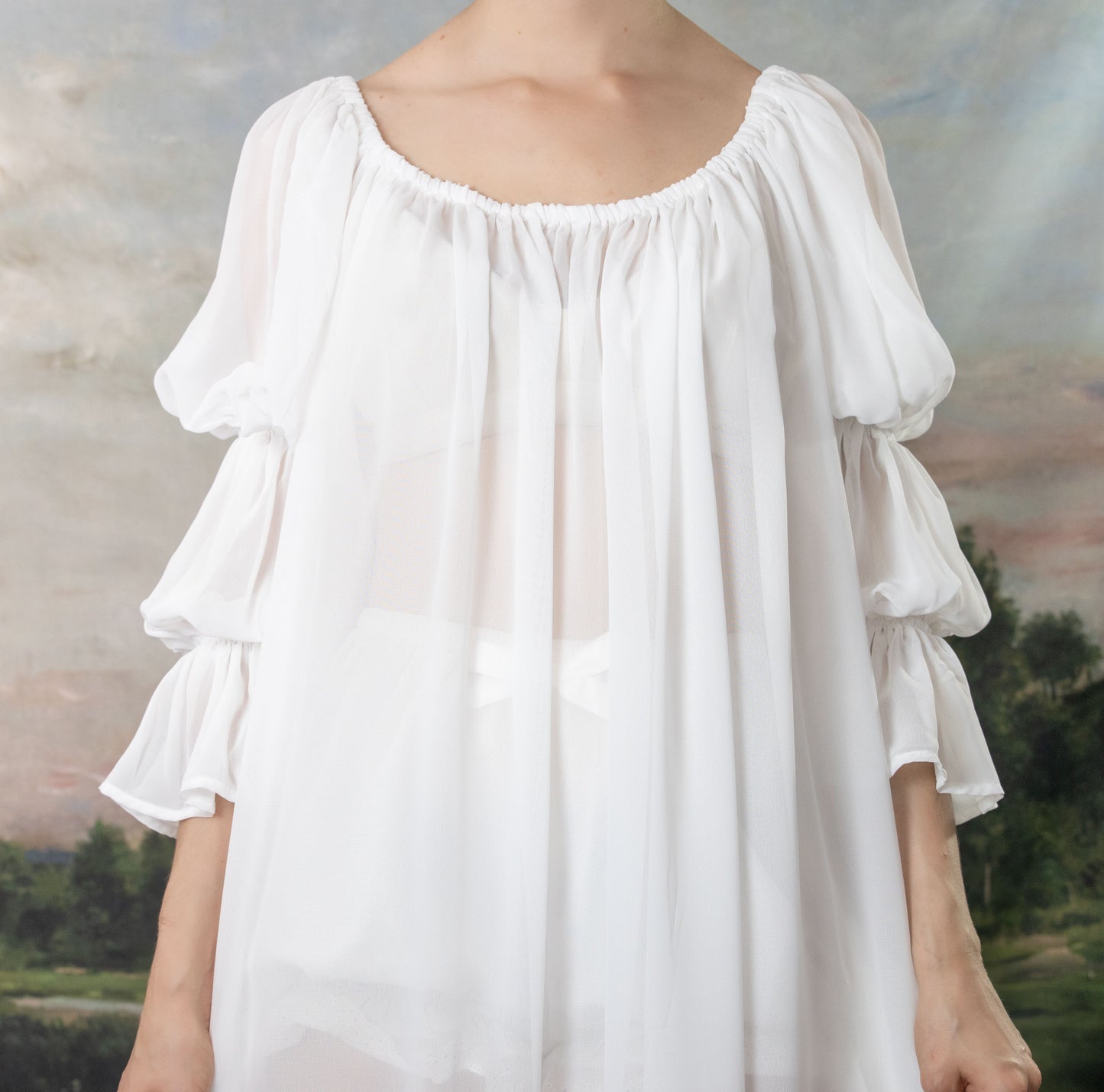 Soft White Chiffon Chemise with elastic neckline and billowing sleeves, shown off-shoulder against pastoral background