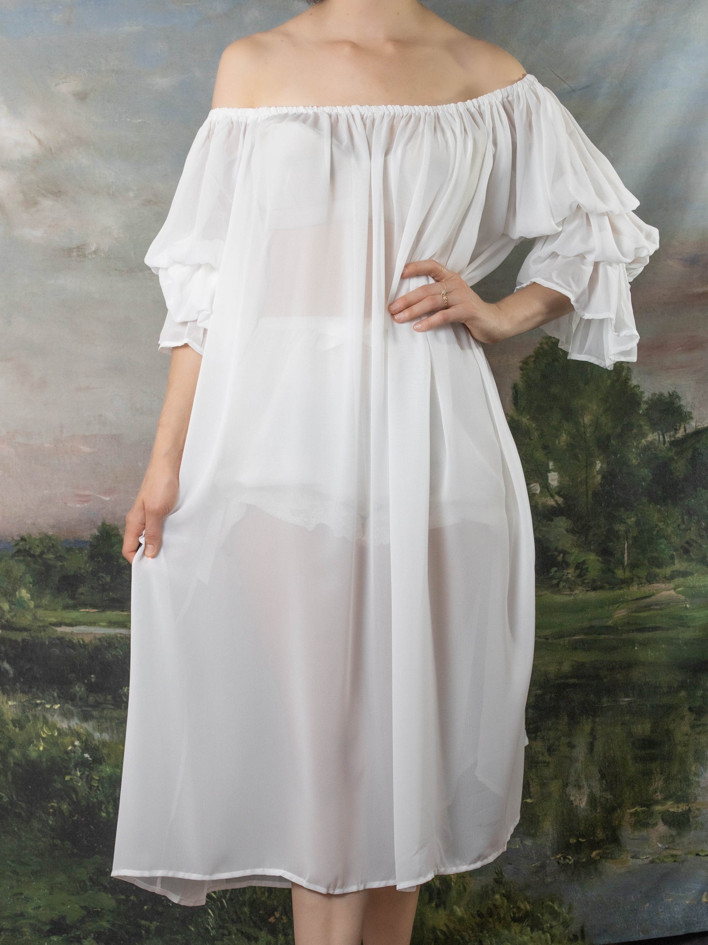 Soft White Chiffon Chemise features off-shoulder design with billowing sleeves and elastic neckline, shown against pastoral backdrop