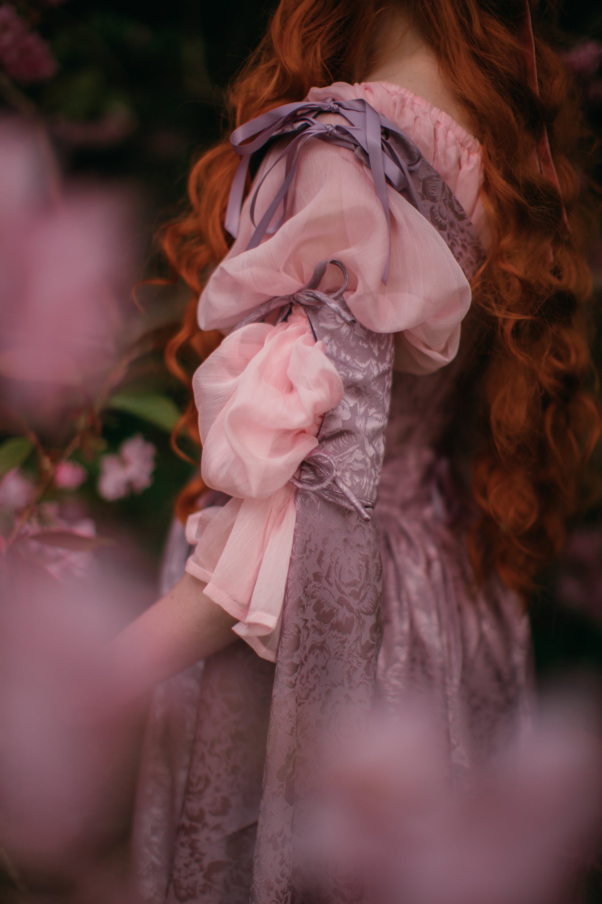 Lavender Floral Satin Corset Dress with floral jacquard fabric, adjustable lacing, and delicate bow-tied shoulder straps.