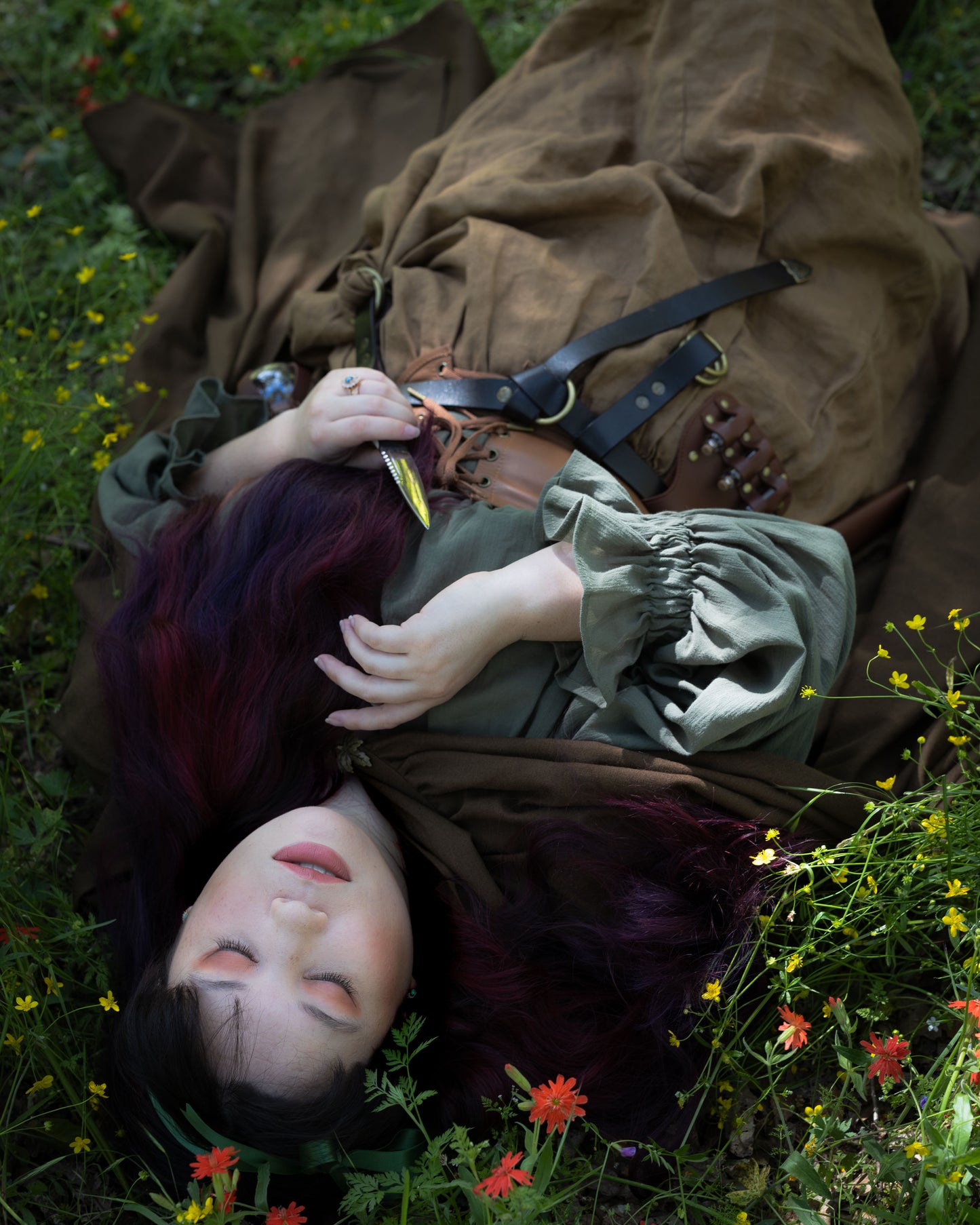 Woman lying in wildflowers wearing the Darcy Shirt with billowing sleeves and vintage-inspired details