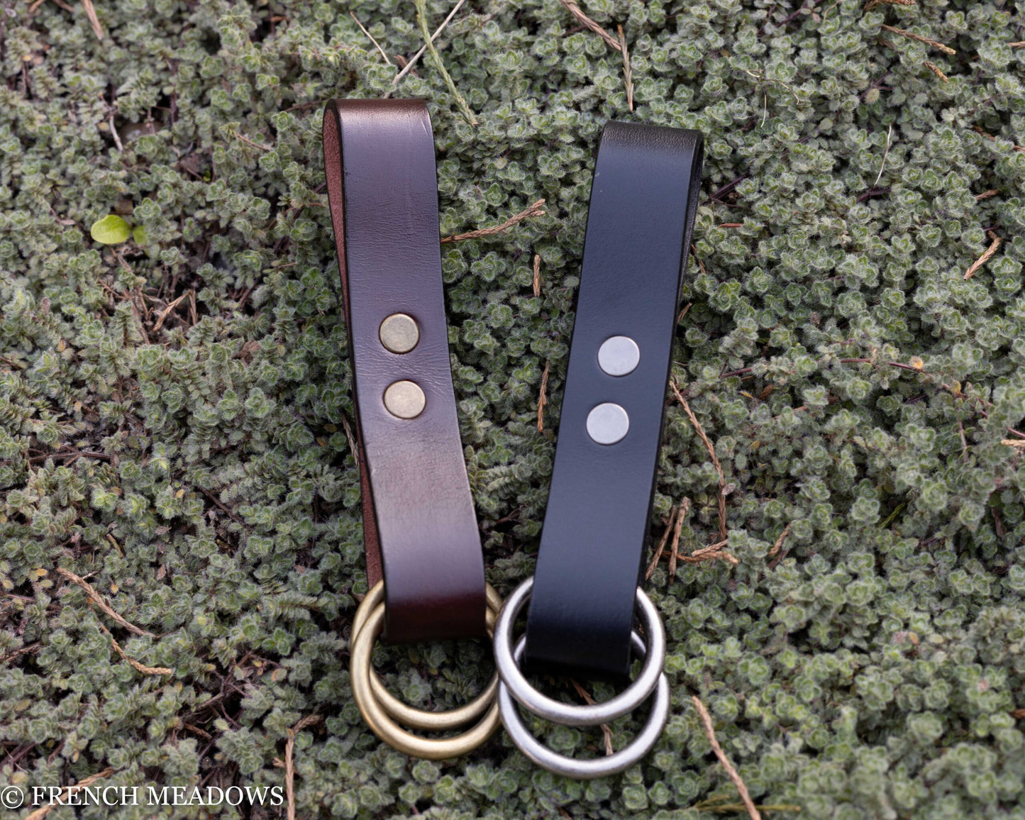 Leather Skirt Hikes in brown and black with metal O-rings displayed on mossy ground, ideal for renaissance costumes