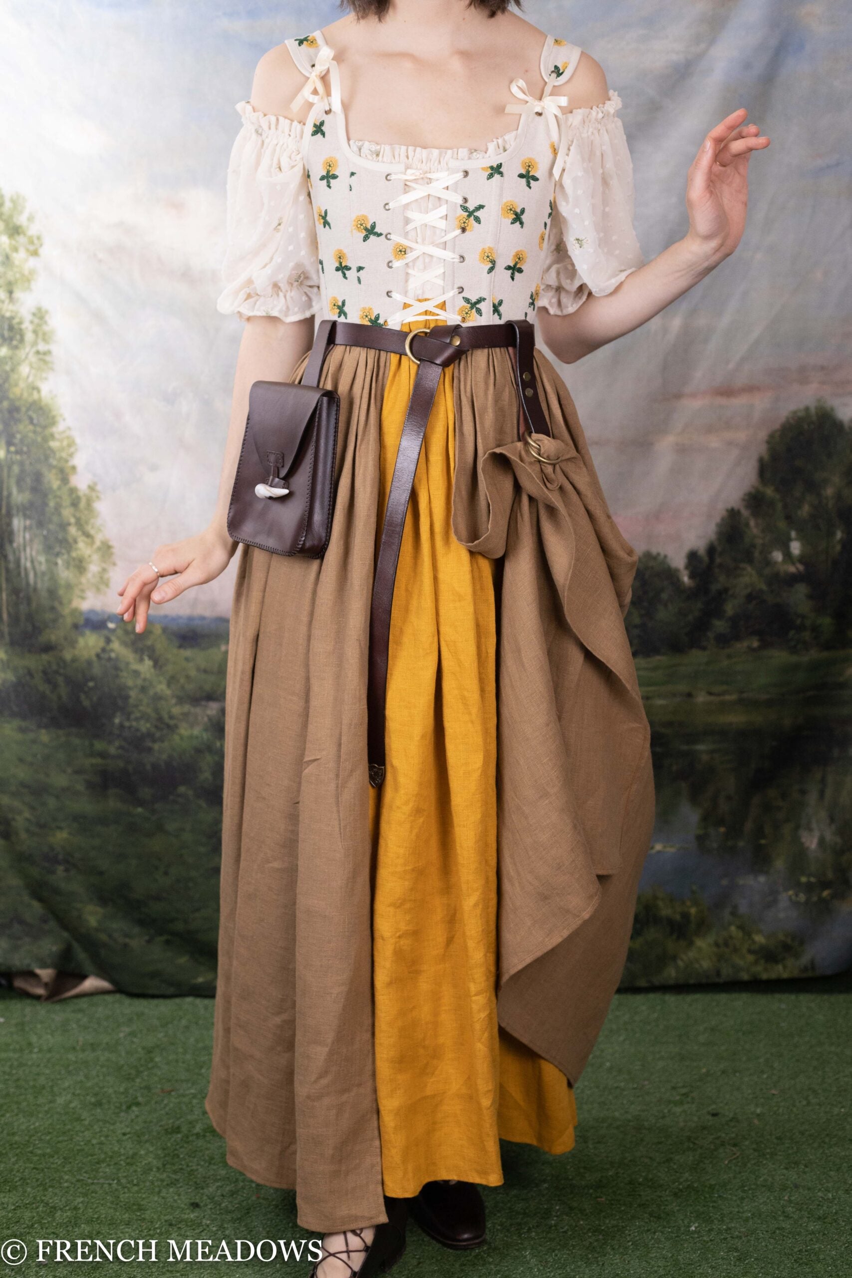 Leather Skirt Hikes shown on Renaissance dress with brown and yellow skirt, floral corset top, and leather accessories
