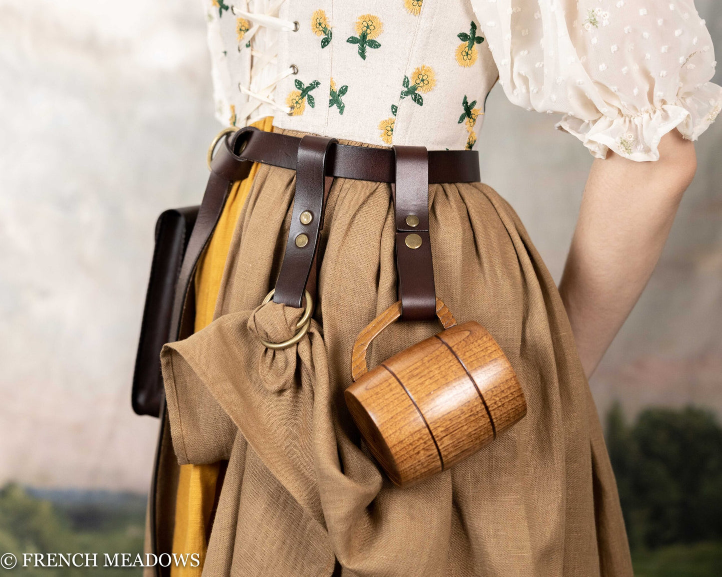 Leather tankard strap on brown skirt with wooden mug, showcasing medieval costume accessory for Renaissance faire wear