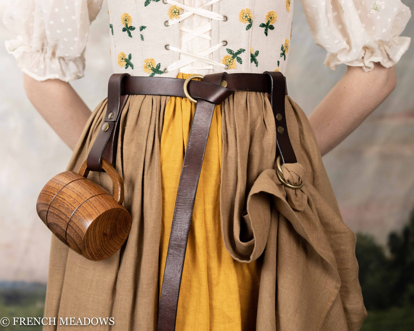 Leather tankard strap on brown belt with wooden mug, shown on tan and yellow renaissance dress with floral embroidered bodice
