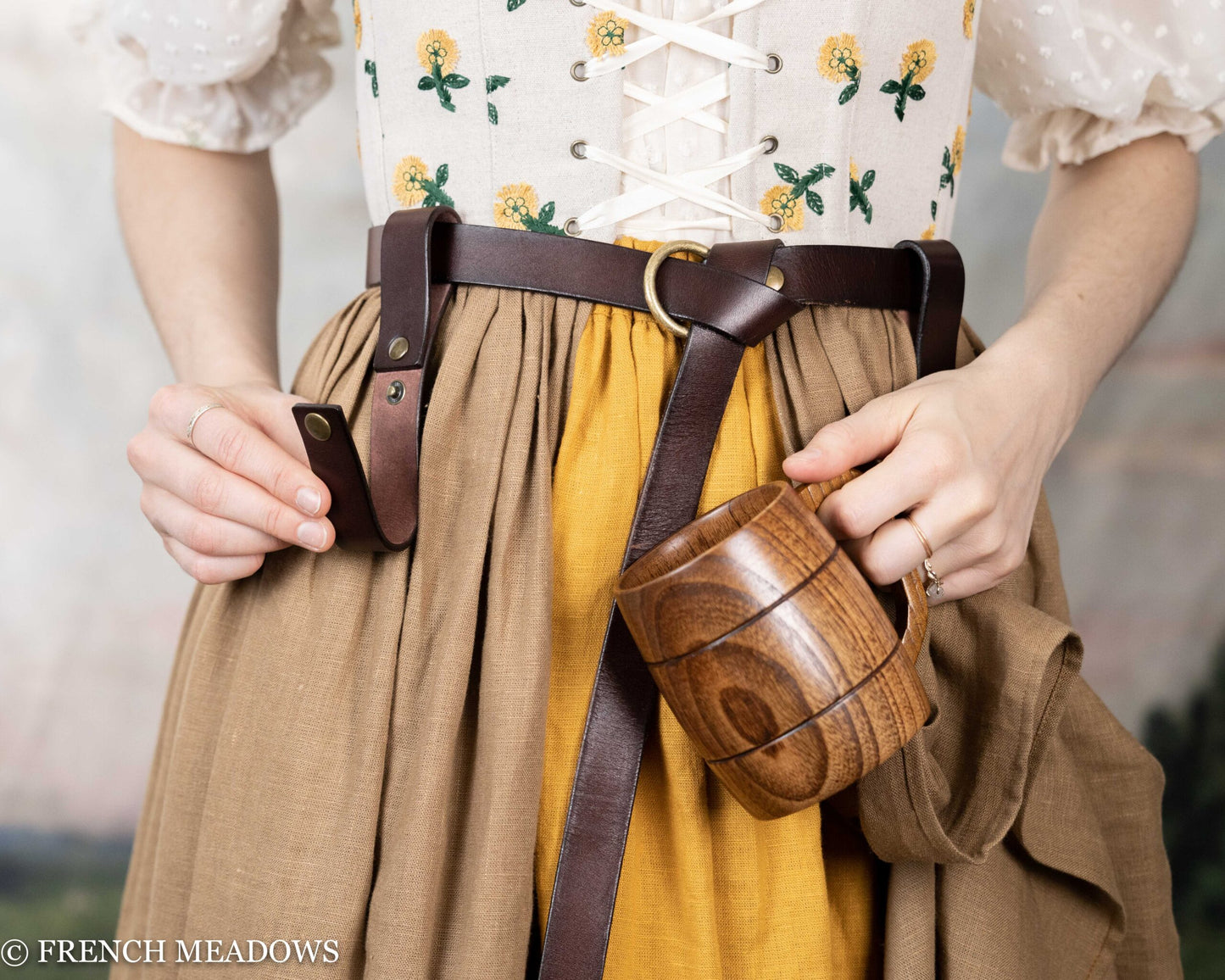 Leather Tankard Strap shown on brown leather belt with wooden mug, attached to Renaissance-style costume with floral bodice