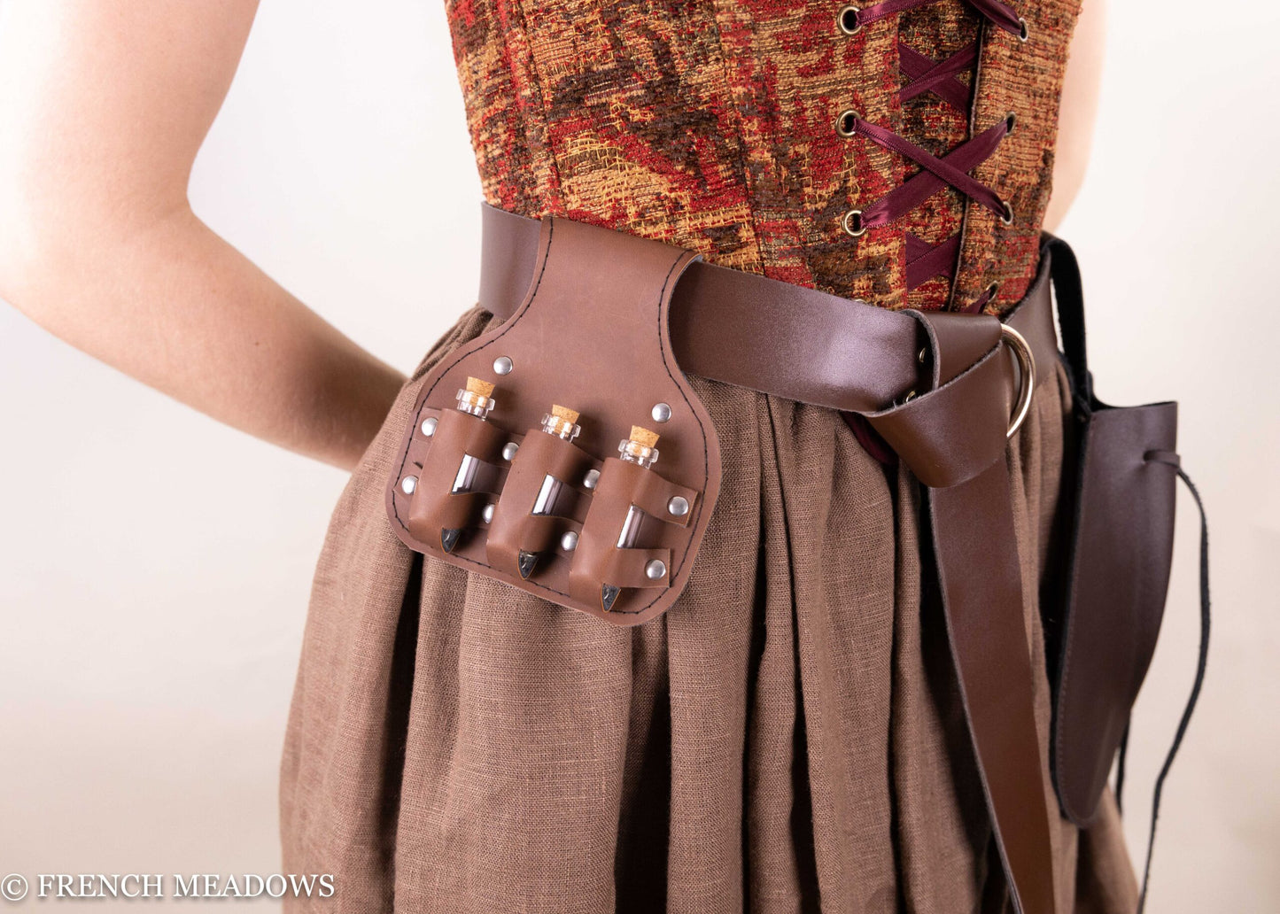 Brown leather Potion Bottle Pouch with glass vials attached to Renaissance costume belt, shown against flowing fabric